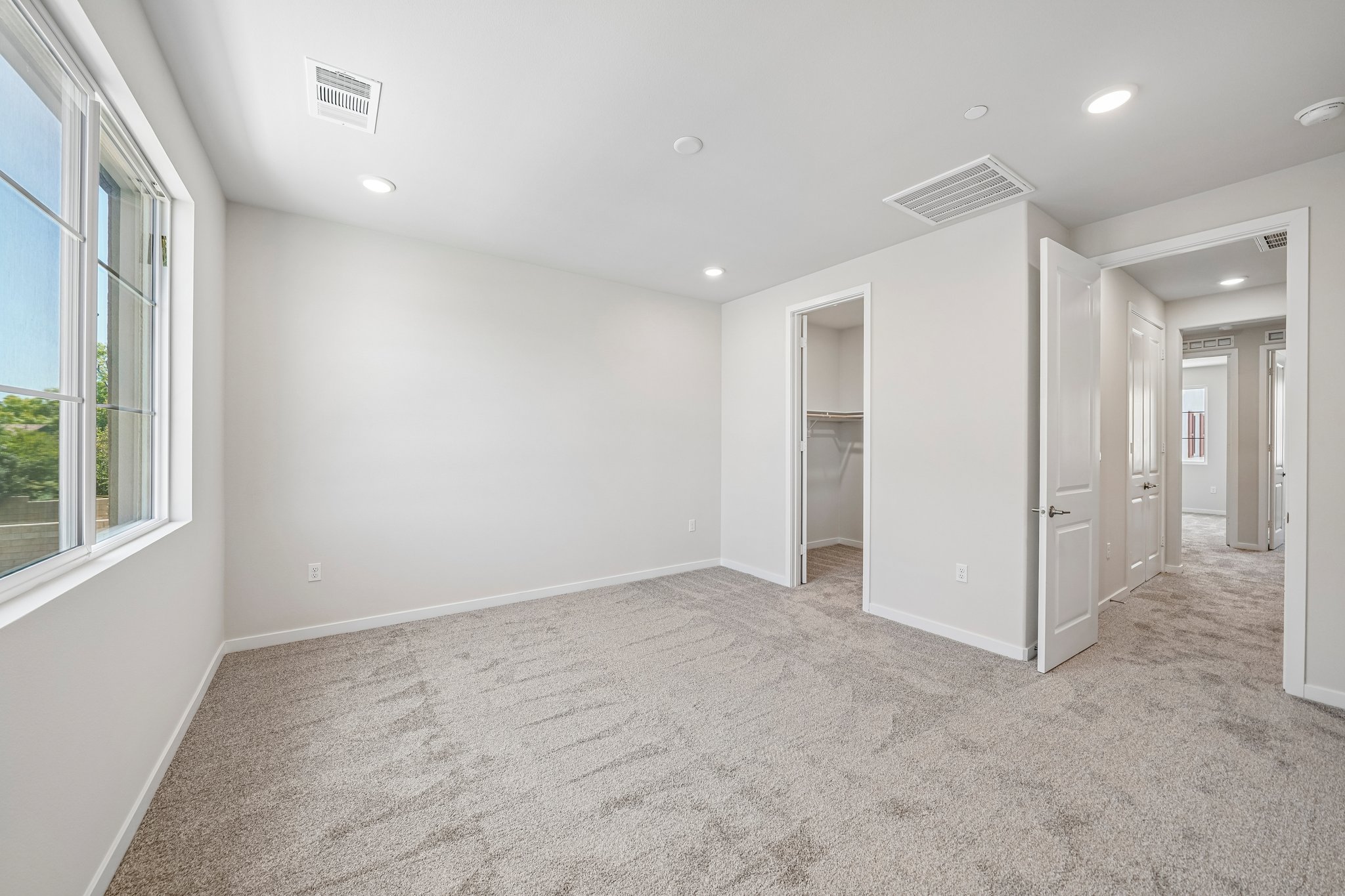 A room with white walls and a carpeted floor.