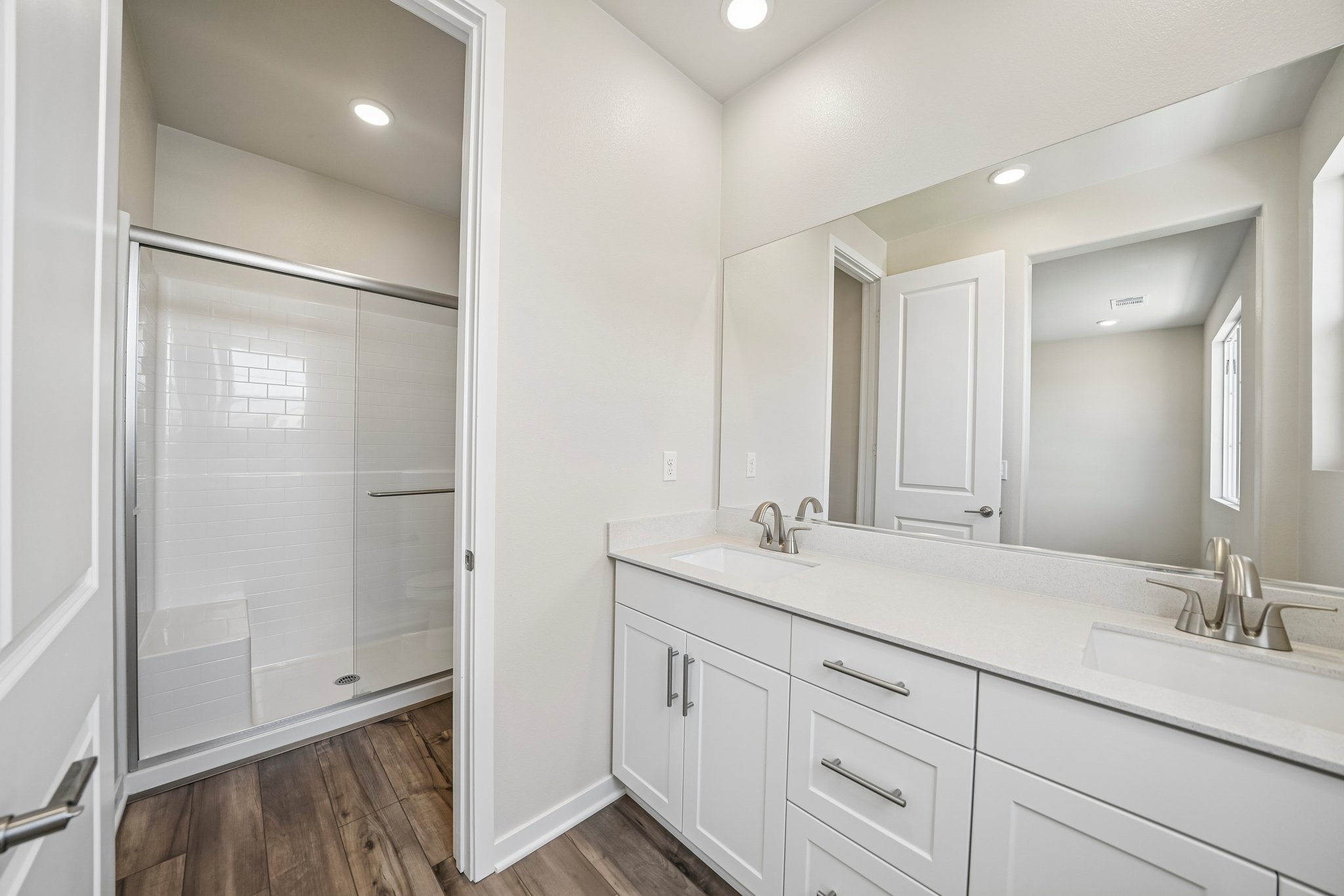 A bathroom with white cabinets.