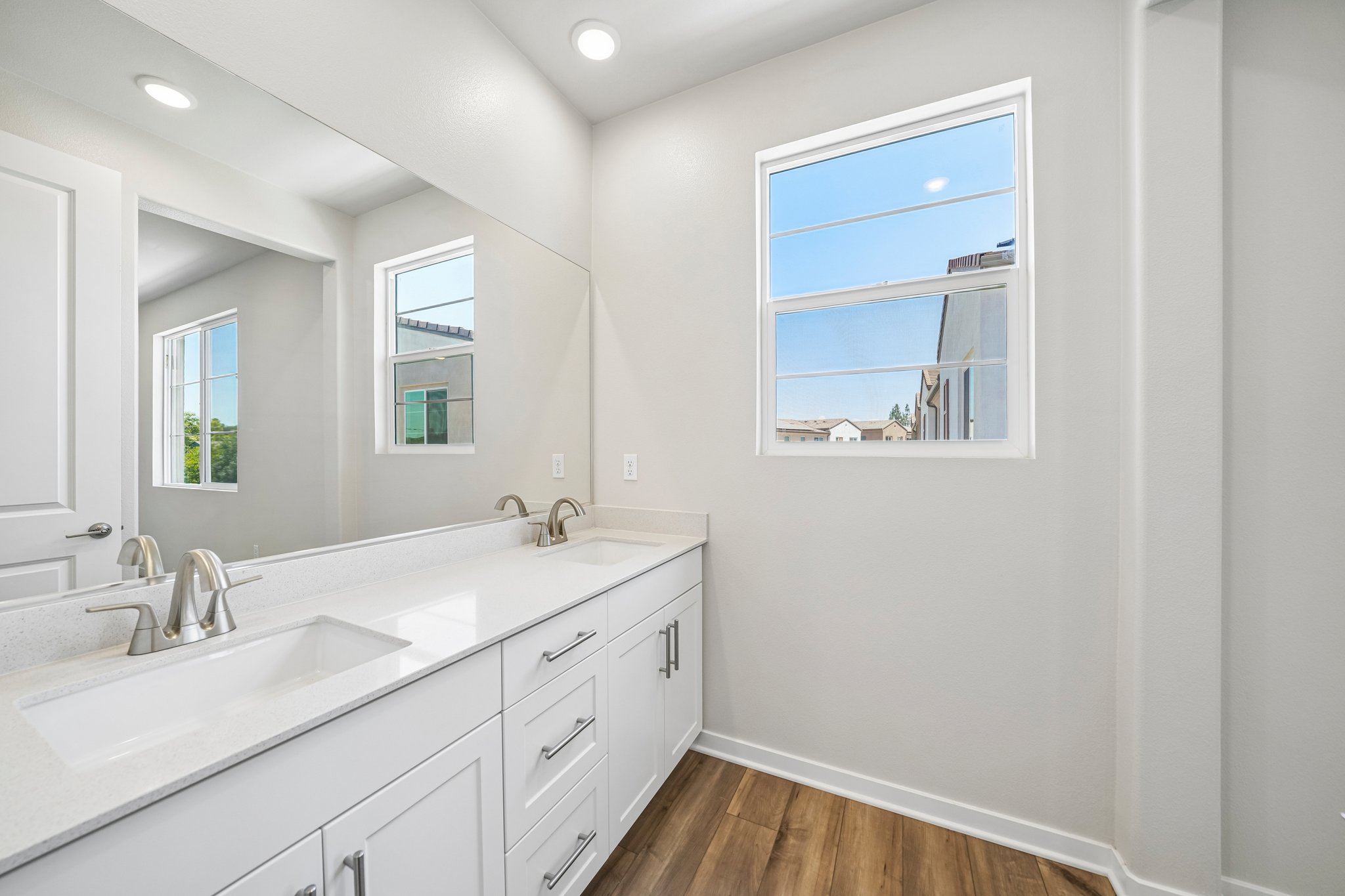 A bathroom with a large mirror.