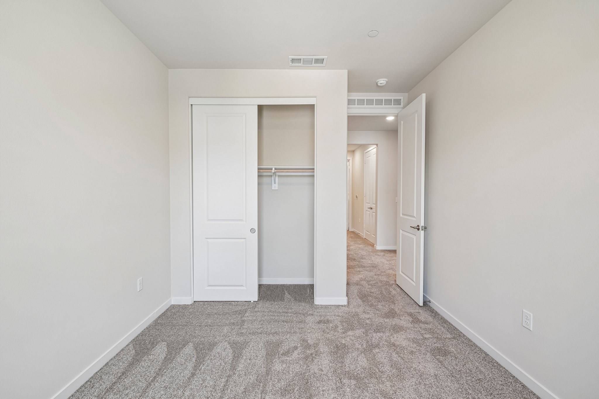 A hallway with white doors.