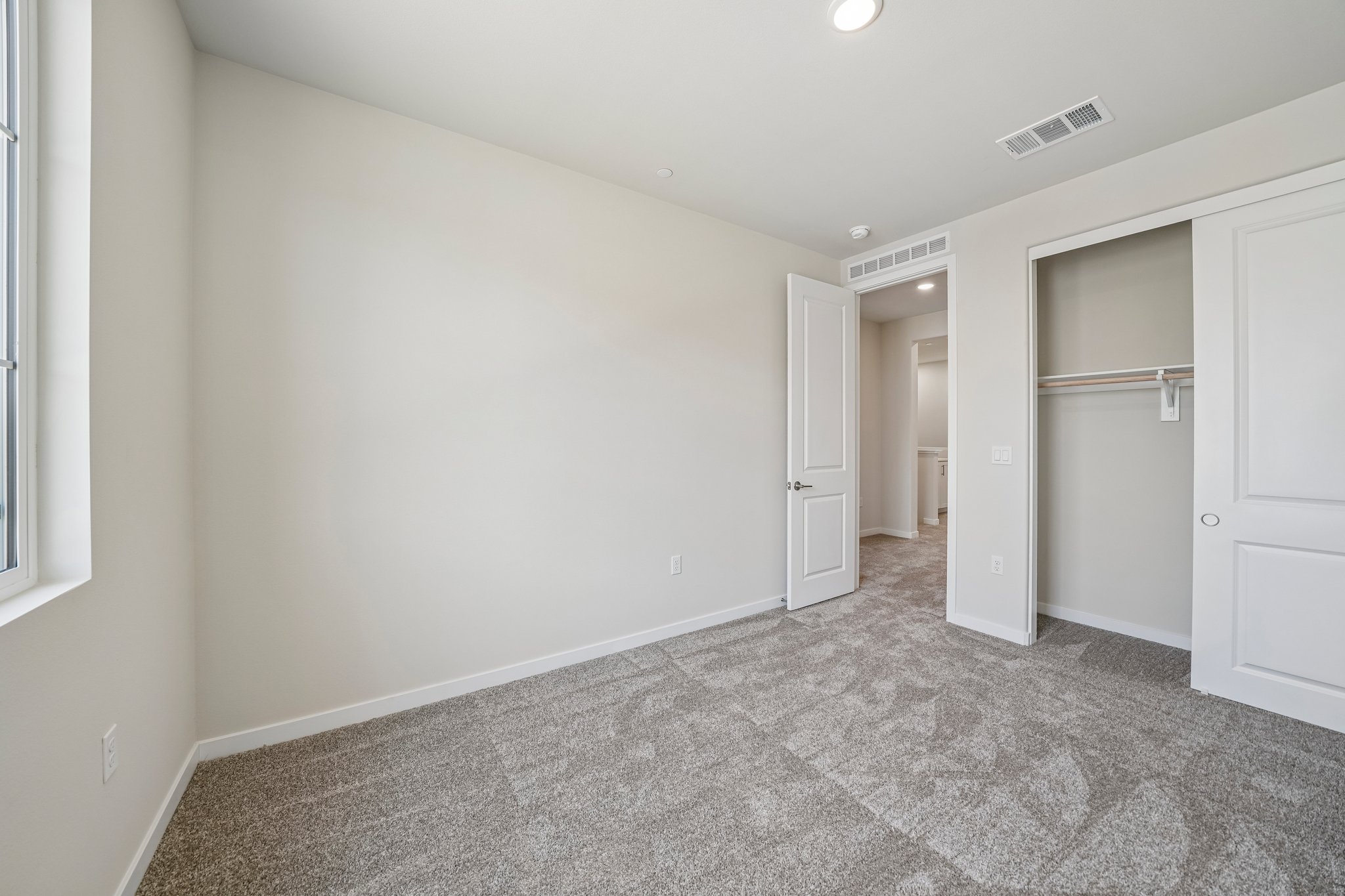 A hallway with white doors.