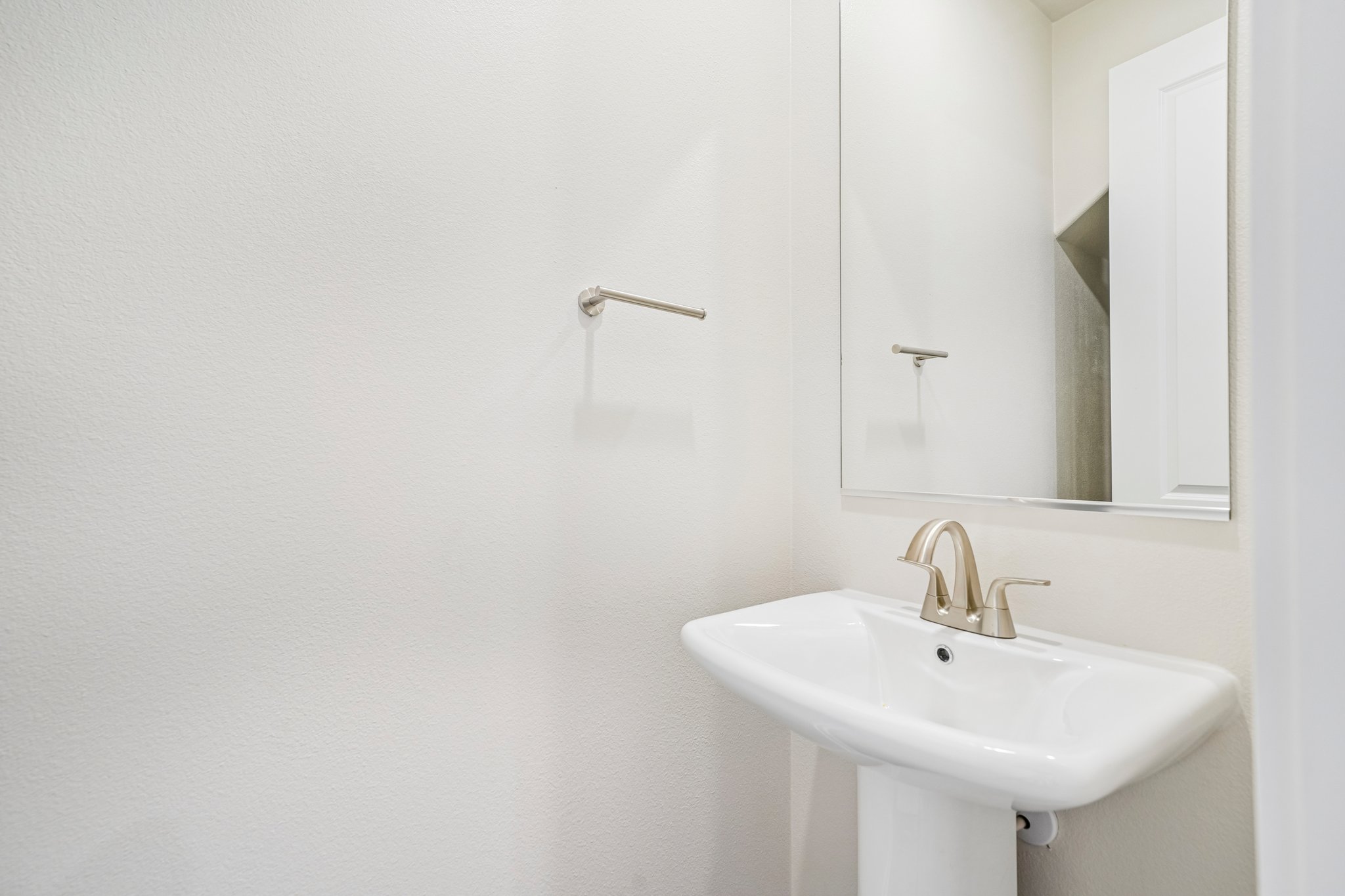A bathroom with a mirror and sink.