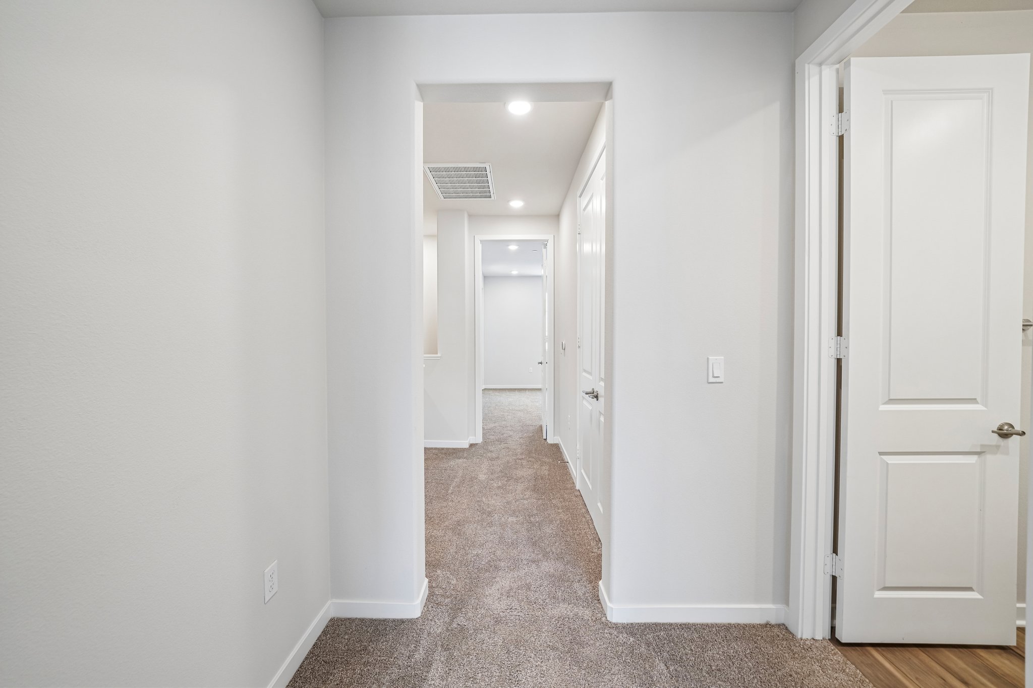 A hallway with white doors.
