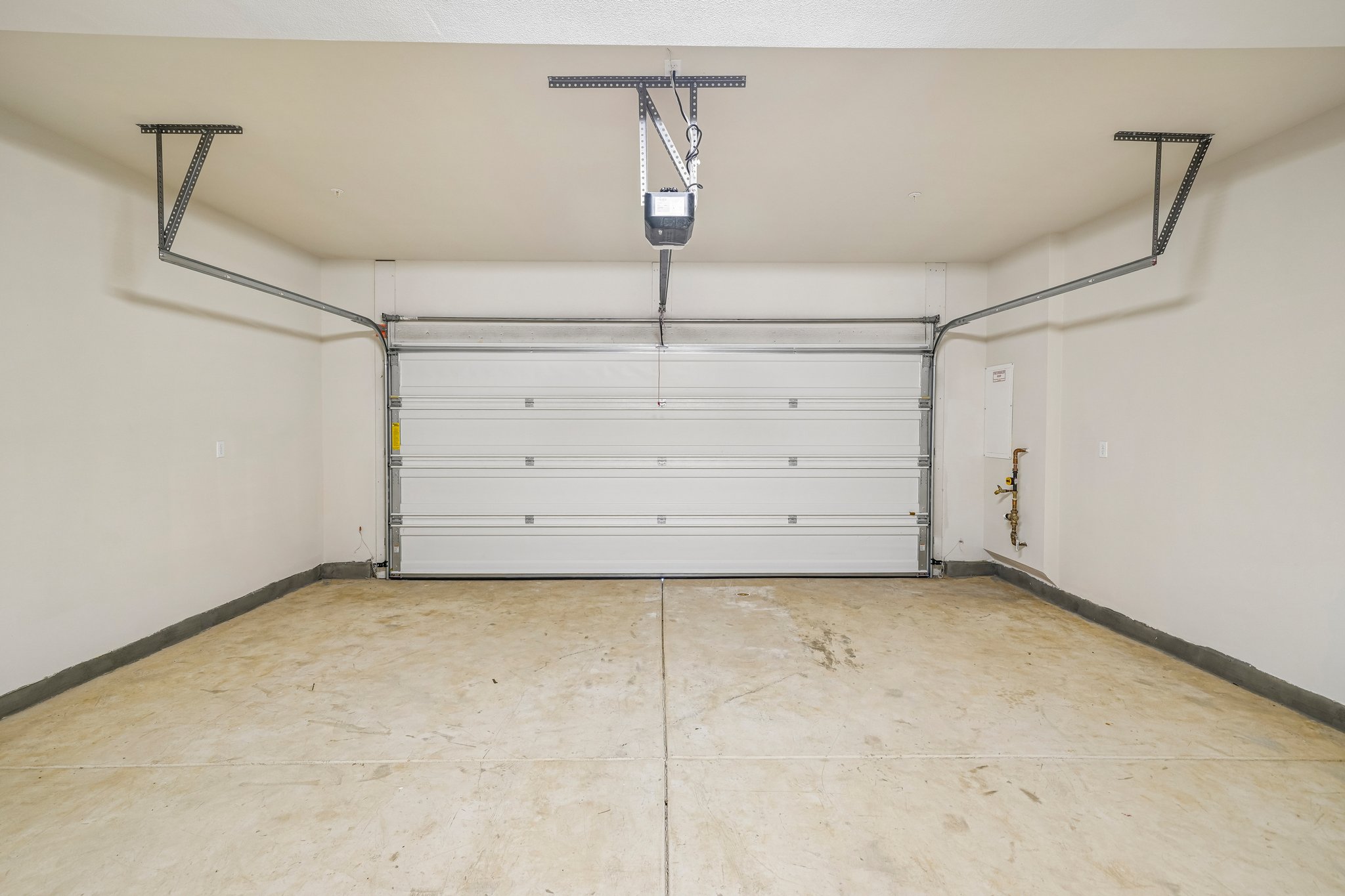 A room with a white door and a metal rack.