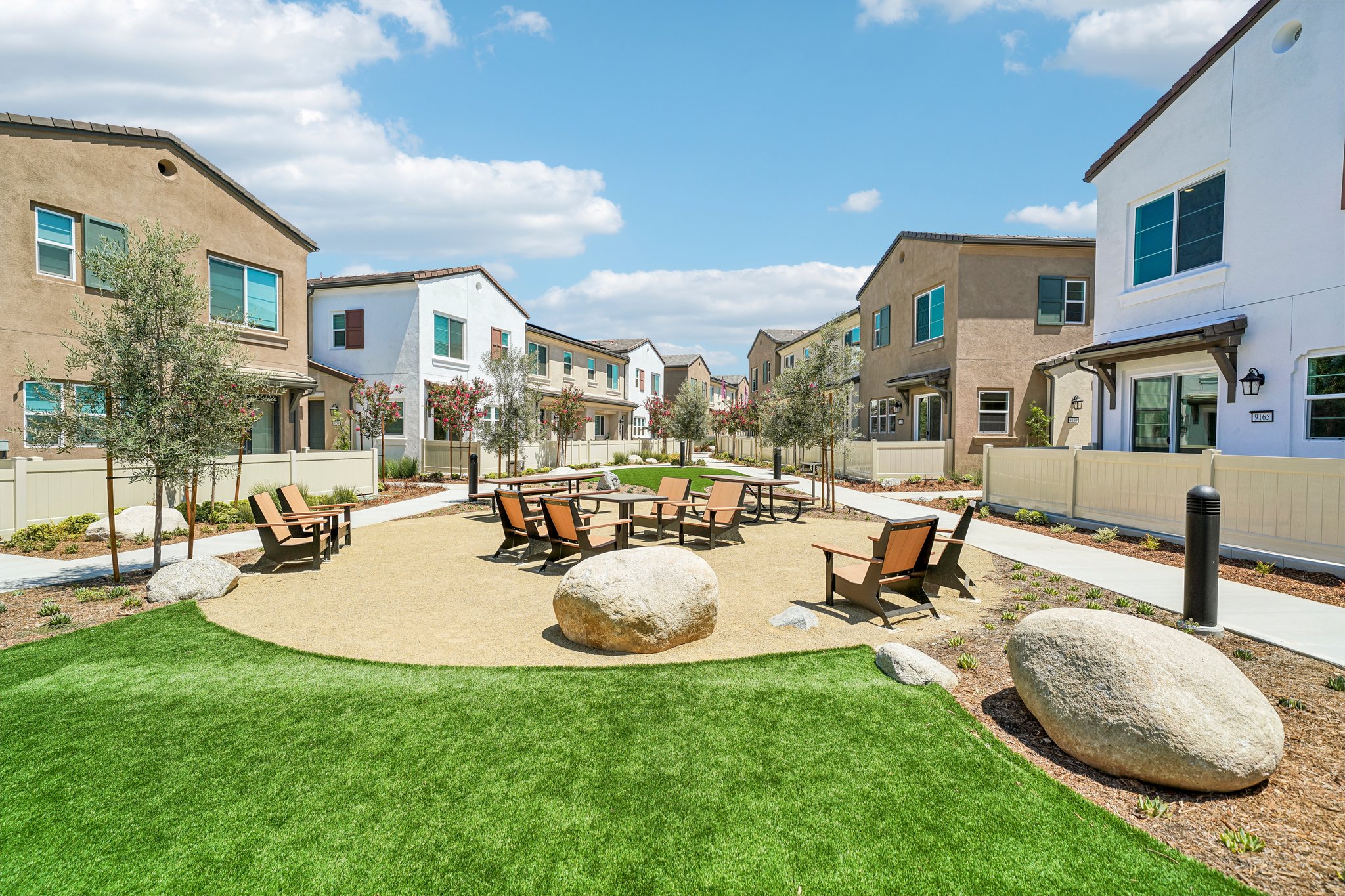 A backyard with a picnic table and chairs.