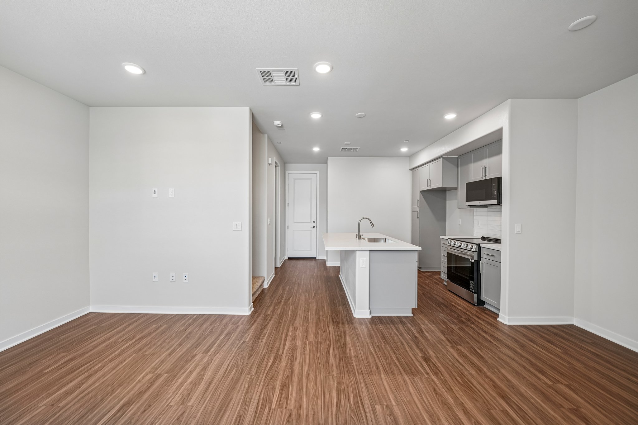 A kitchen with white cabinets.