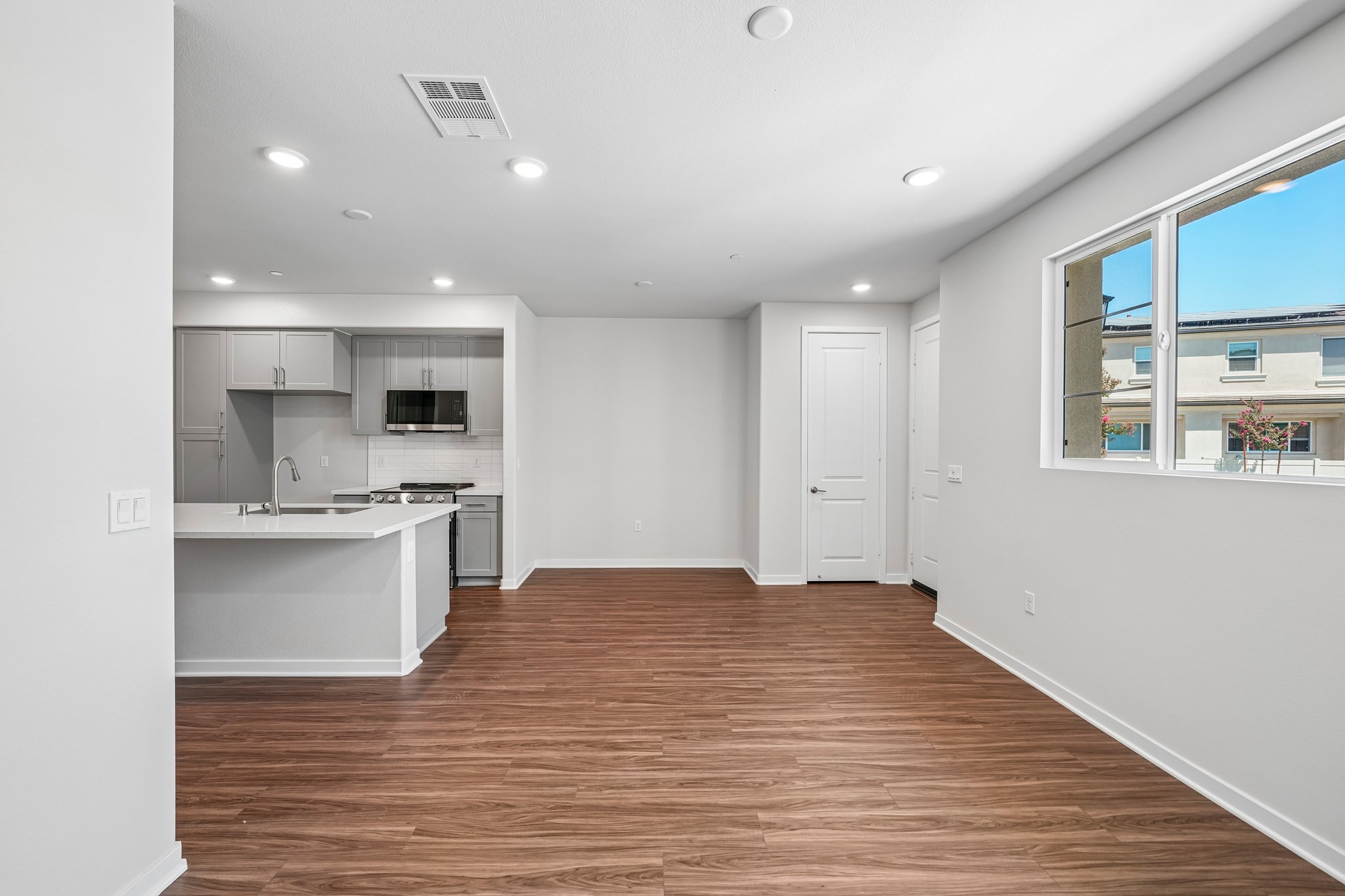 A large kitchen with white walls.