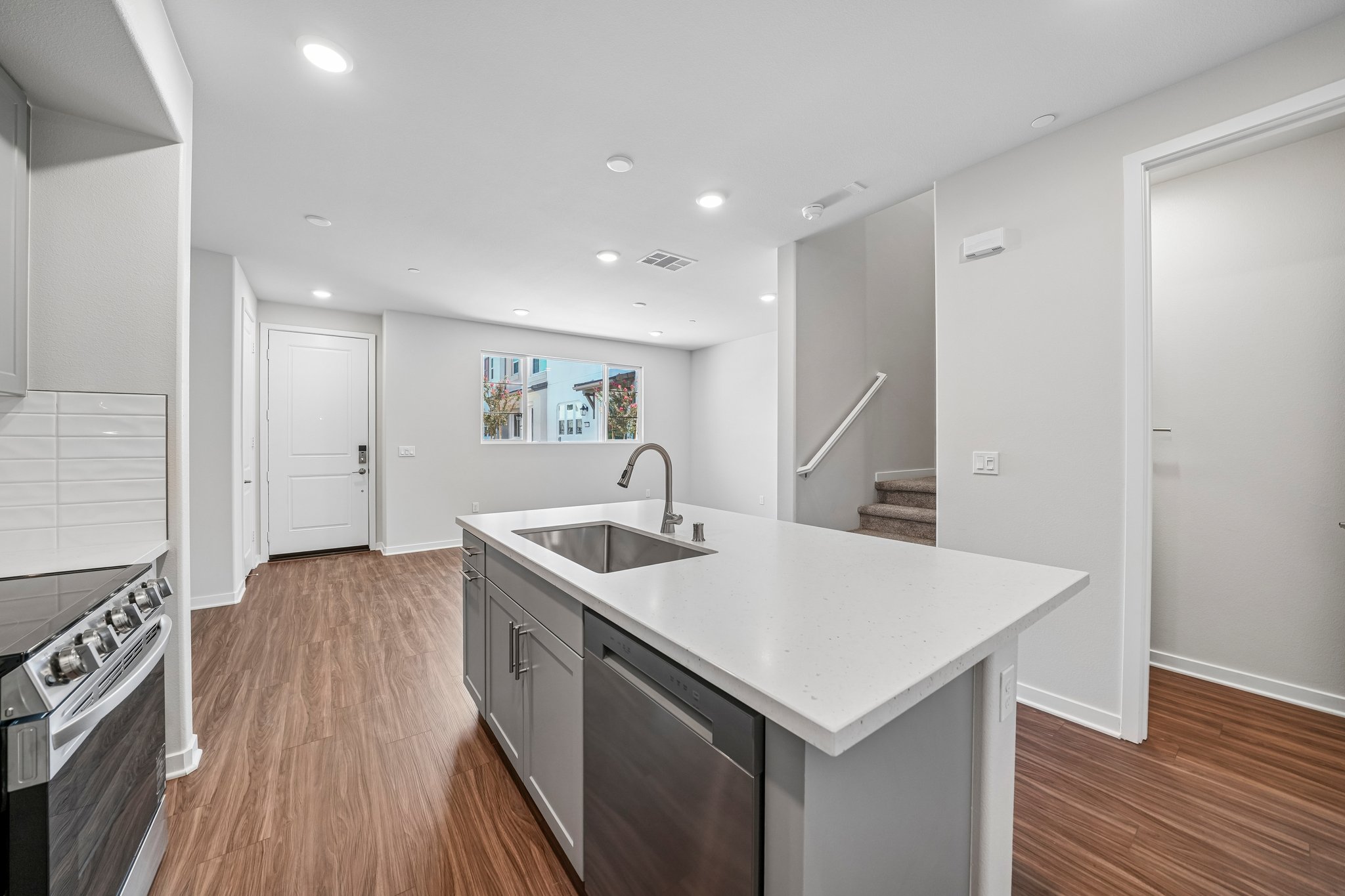 A kitchen with a sink and a stove.