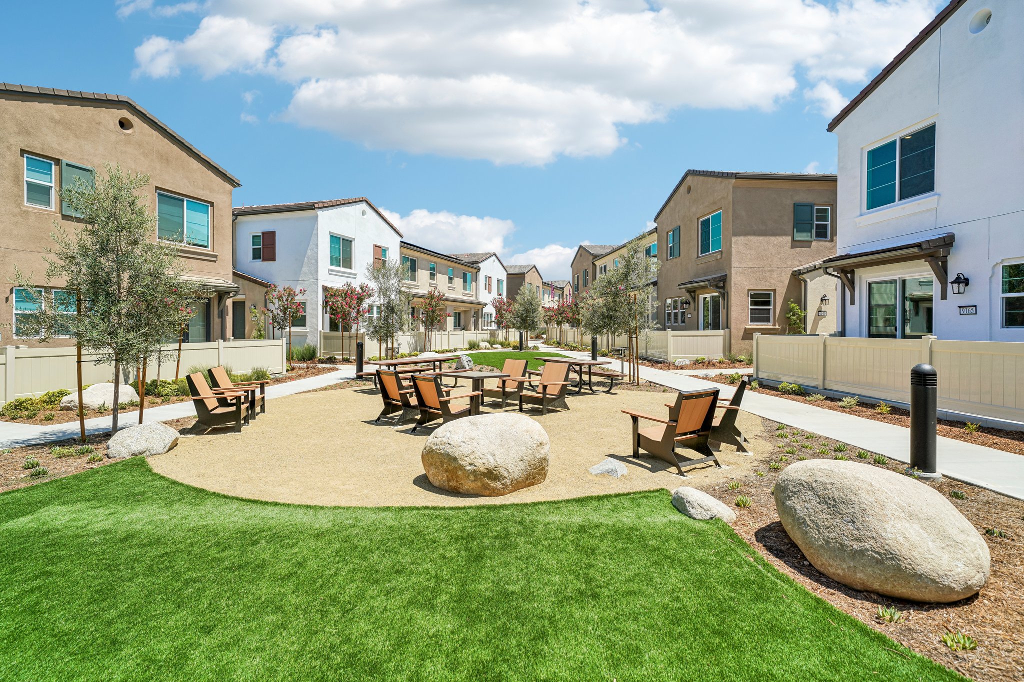 A backyard with a picnic table and chairs.
