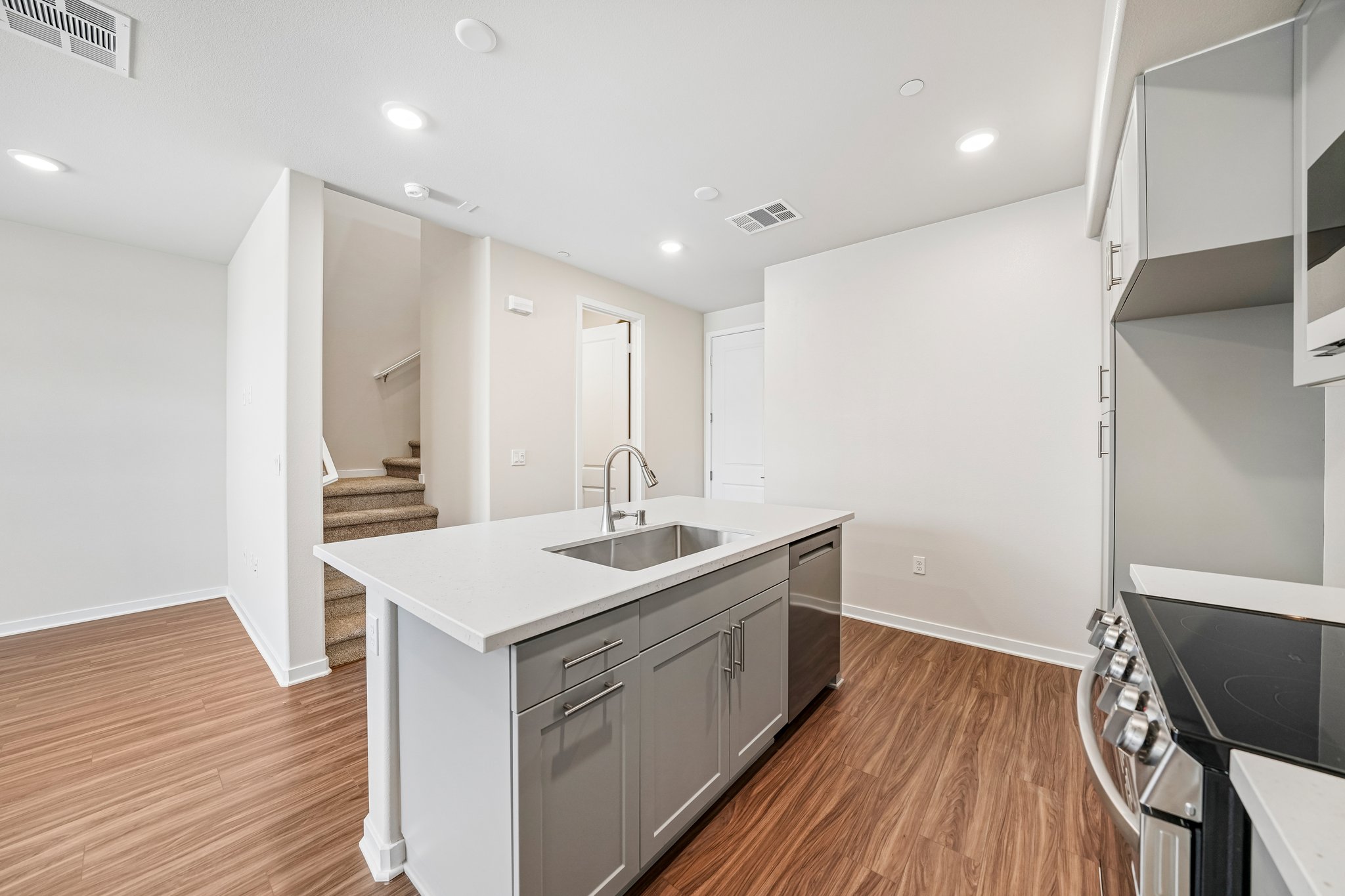 A kitchen with white cabinets.