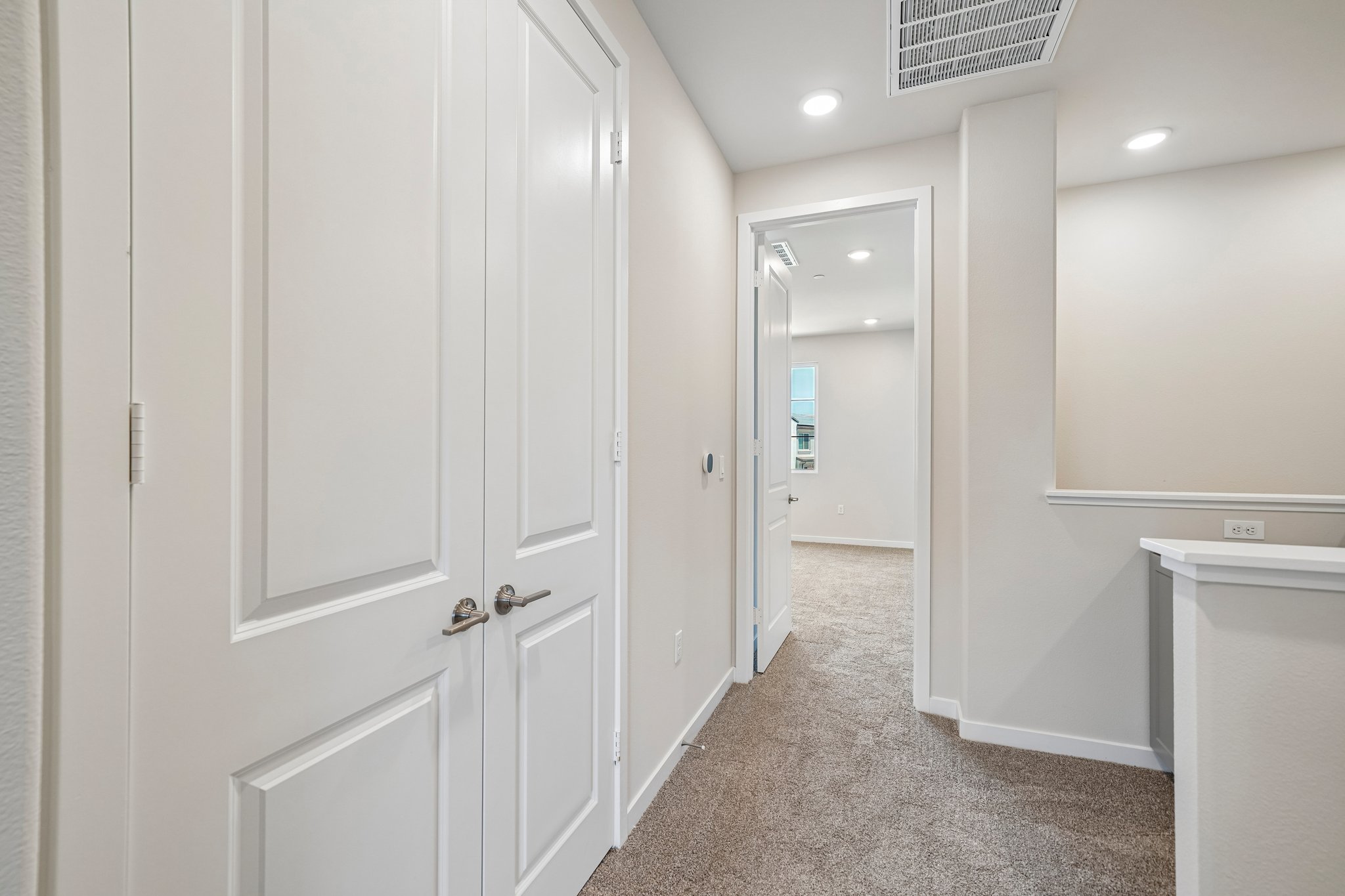A hallway with white doors.