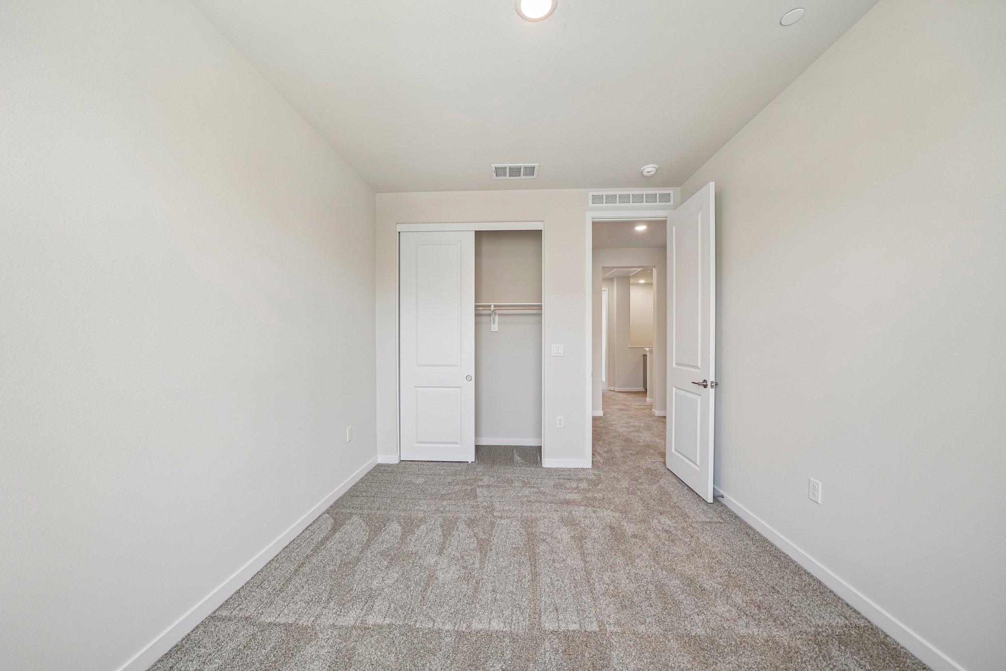 A hallway with white doors.