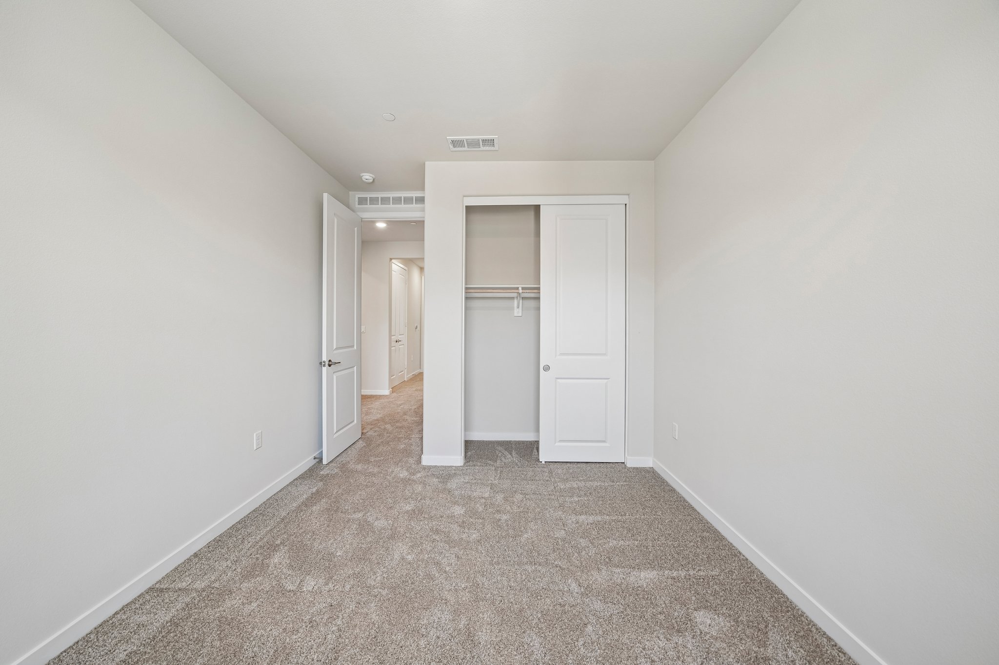 A hallway with white doors.