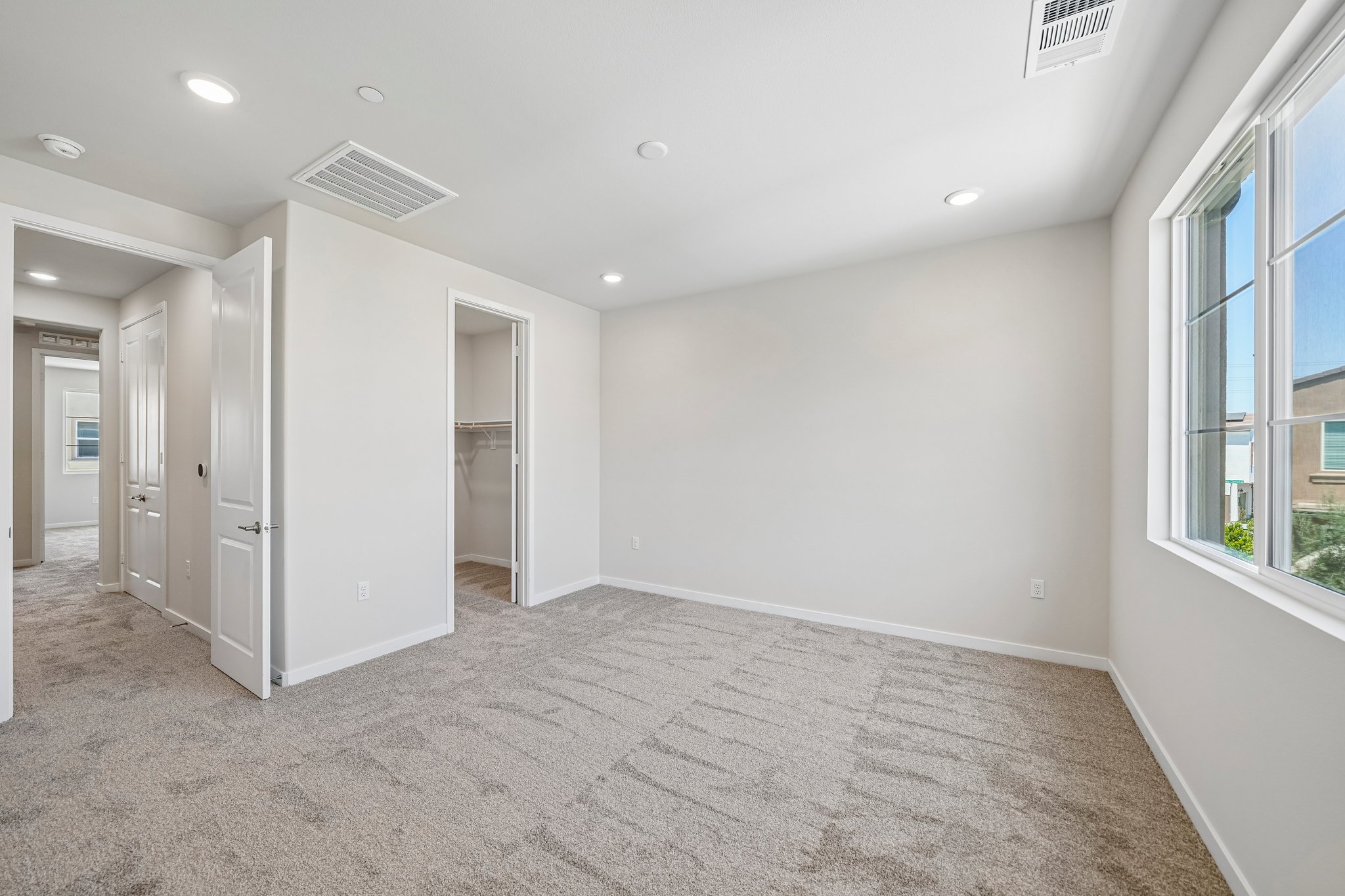 A room with white walls and windows.