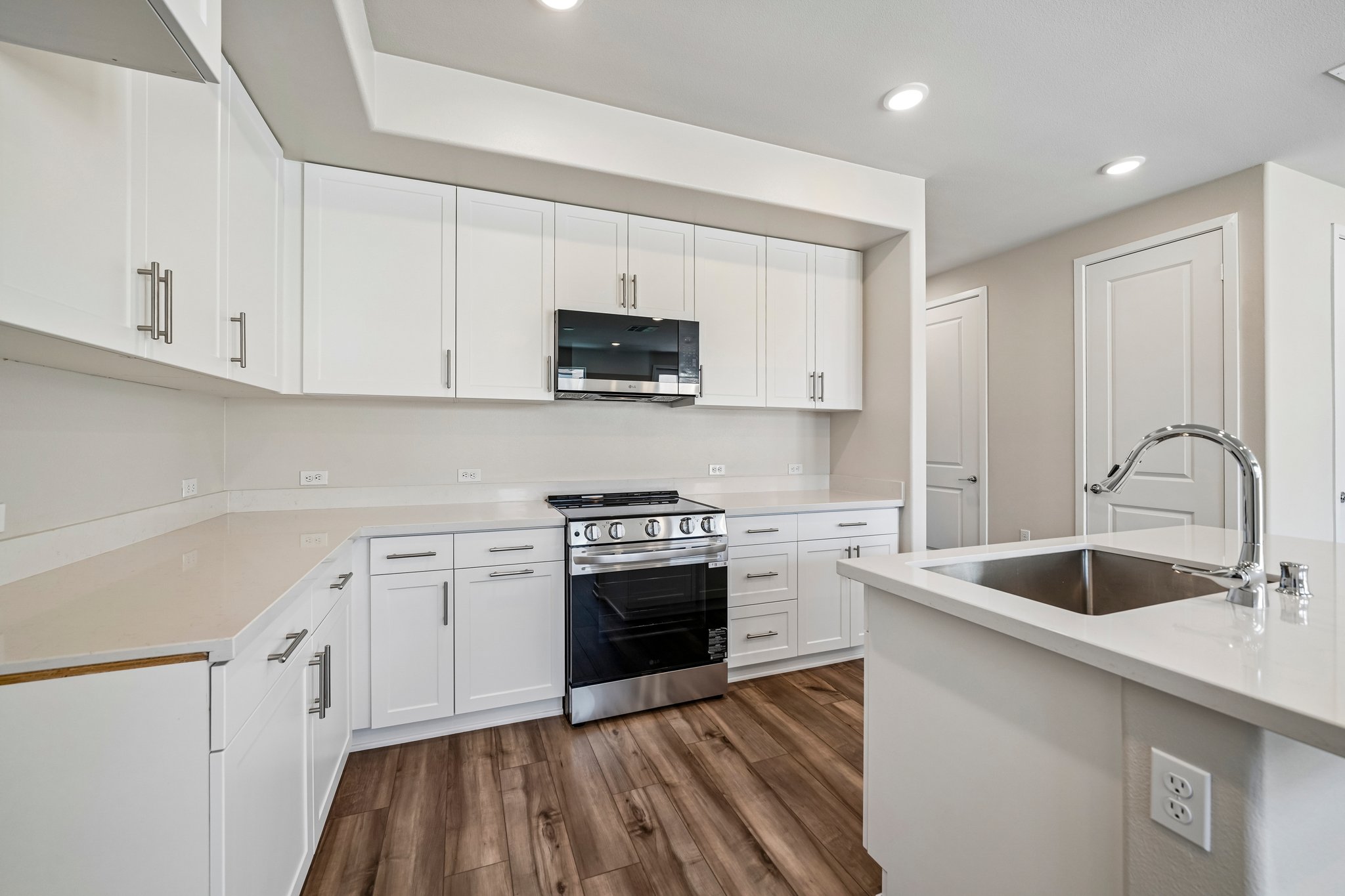A kitchen with white cabinets.