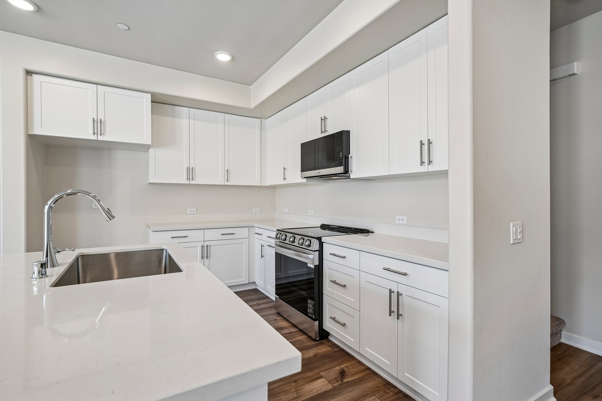 A kitchen with white cabinets.