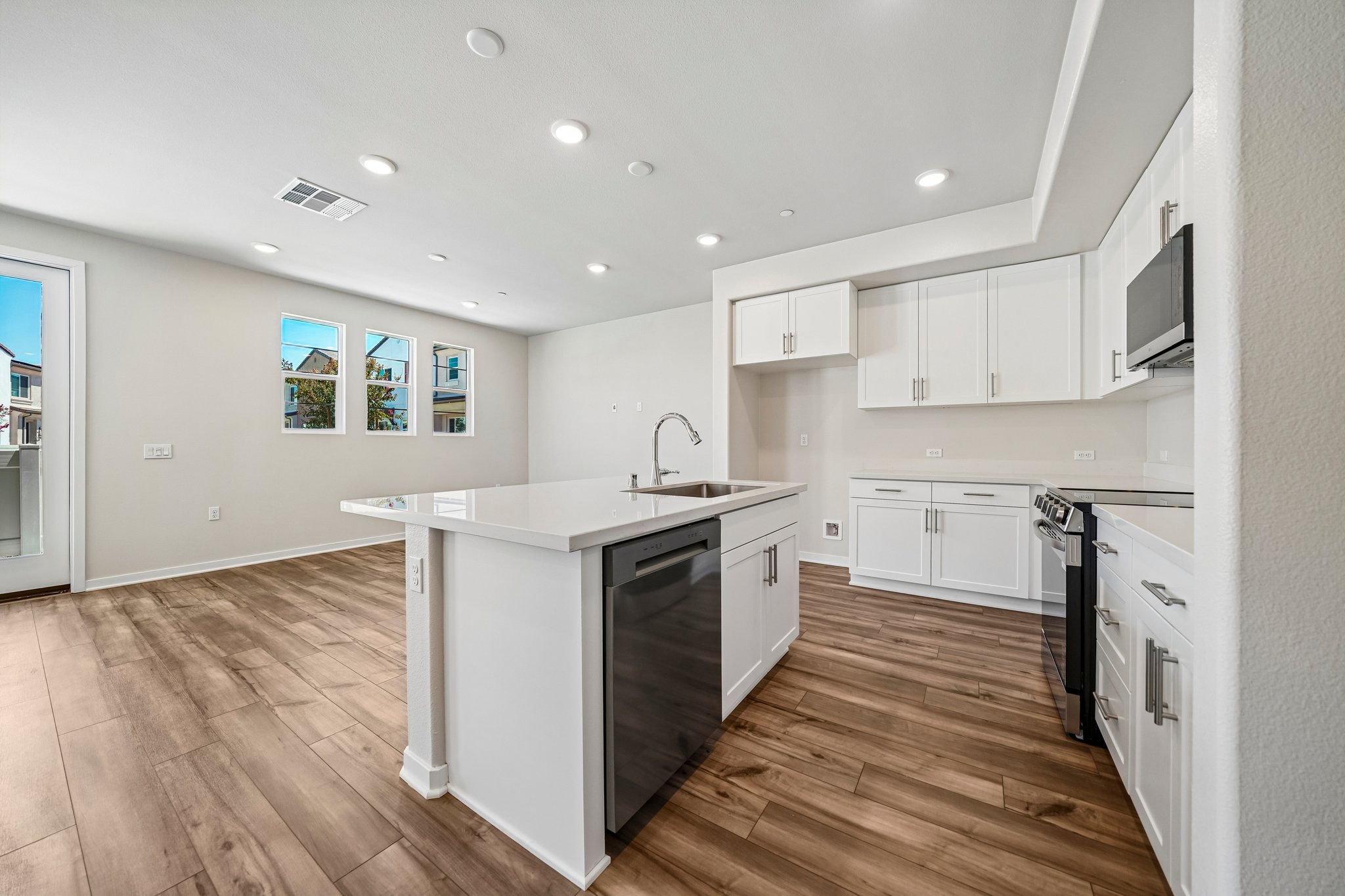 A kitchen with white cabinets.