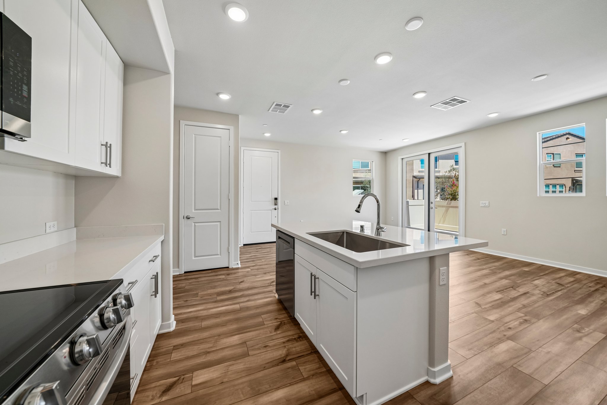 A kitchen with white cabinets.