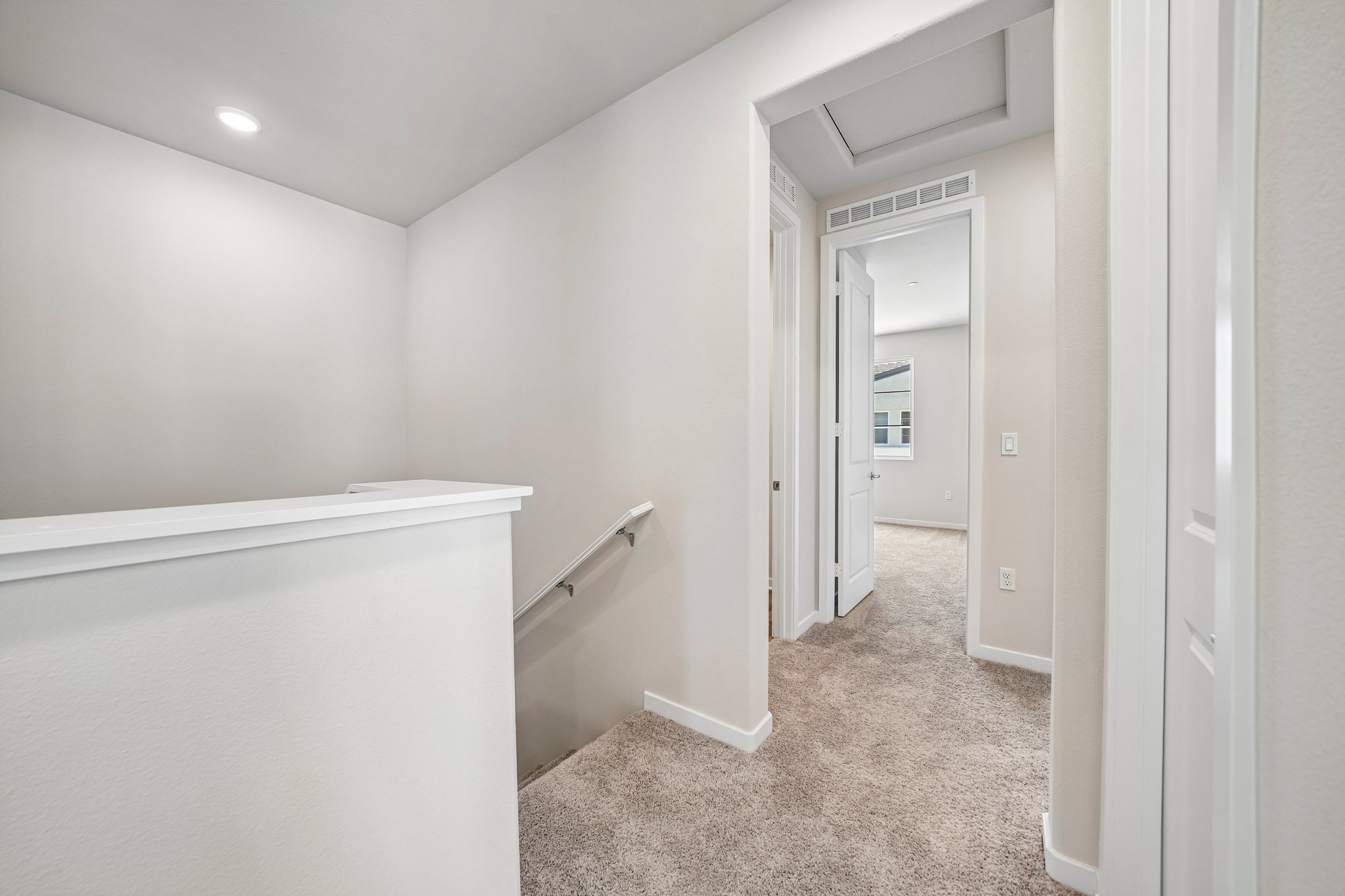 A hallway with white walls.