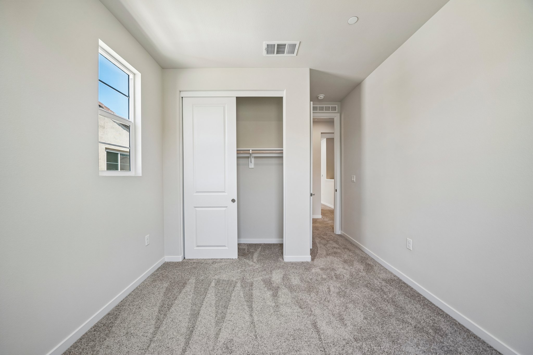 A hallway with white doors.