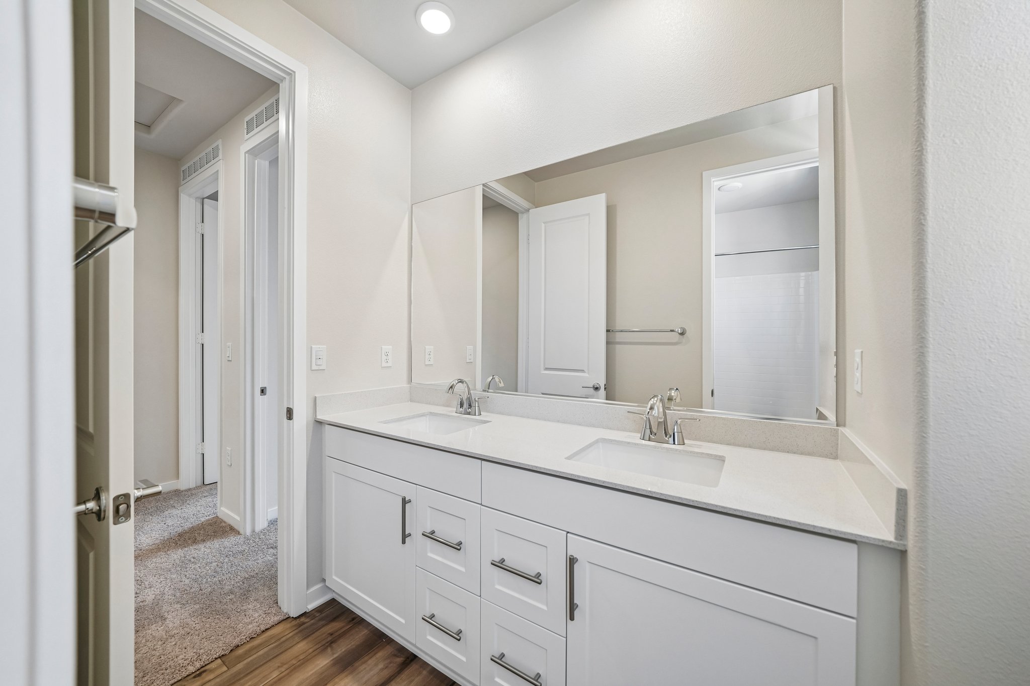A bathroom with a large mirror.