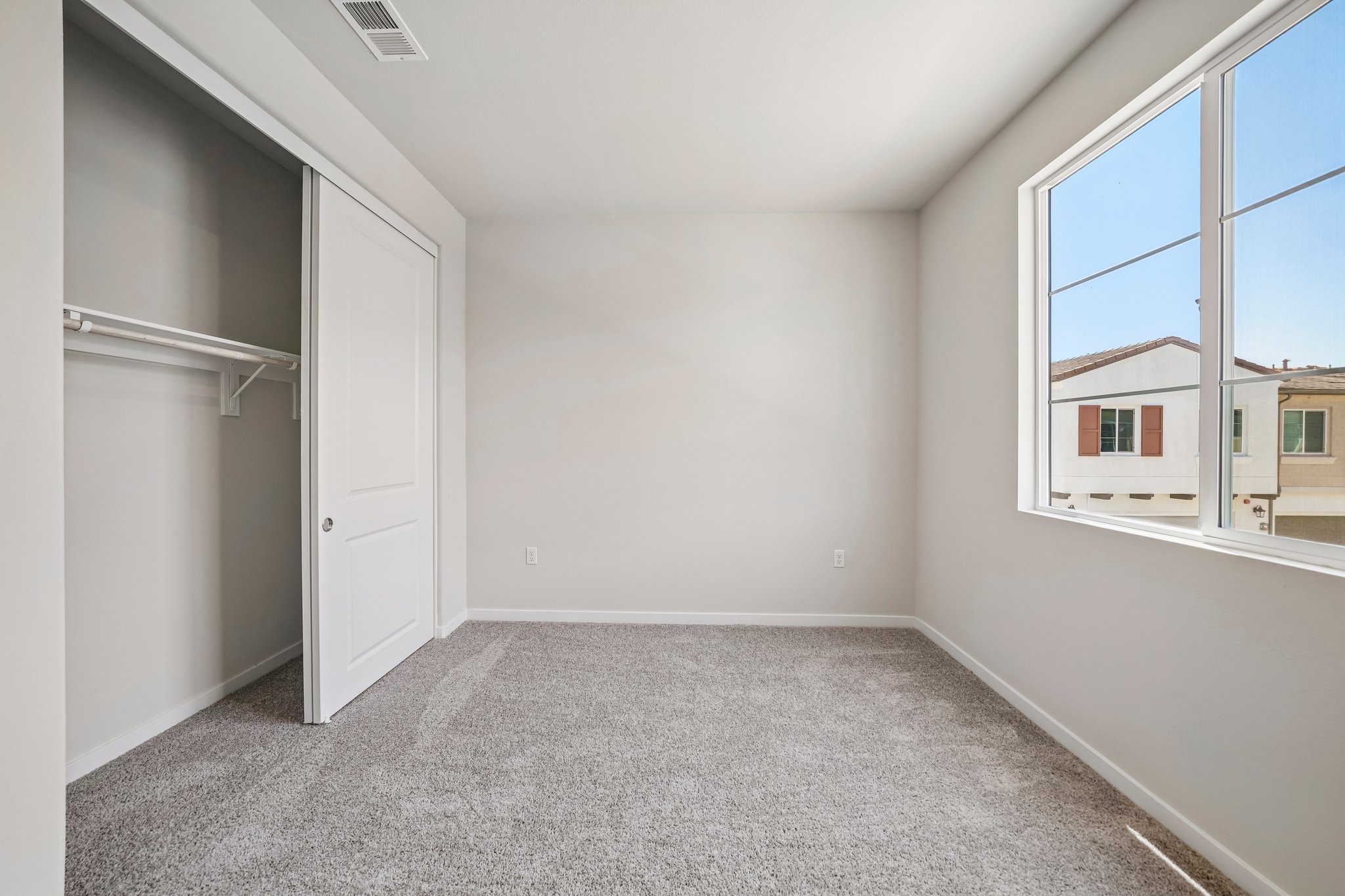 A room with a window and a door.