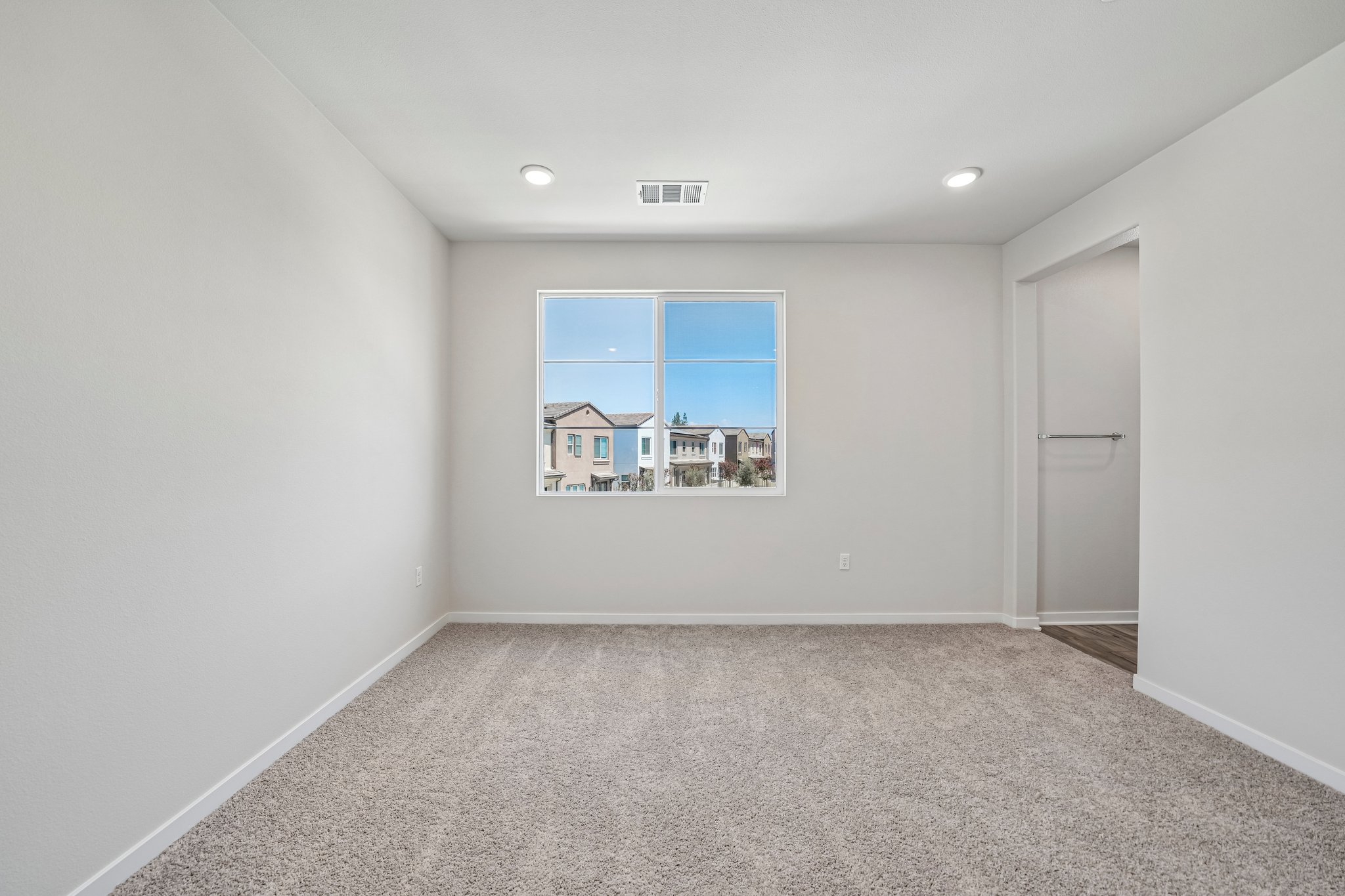 A room with a window and a door.