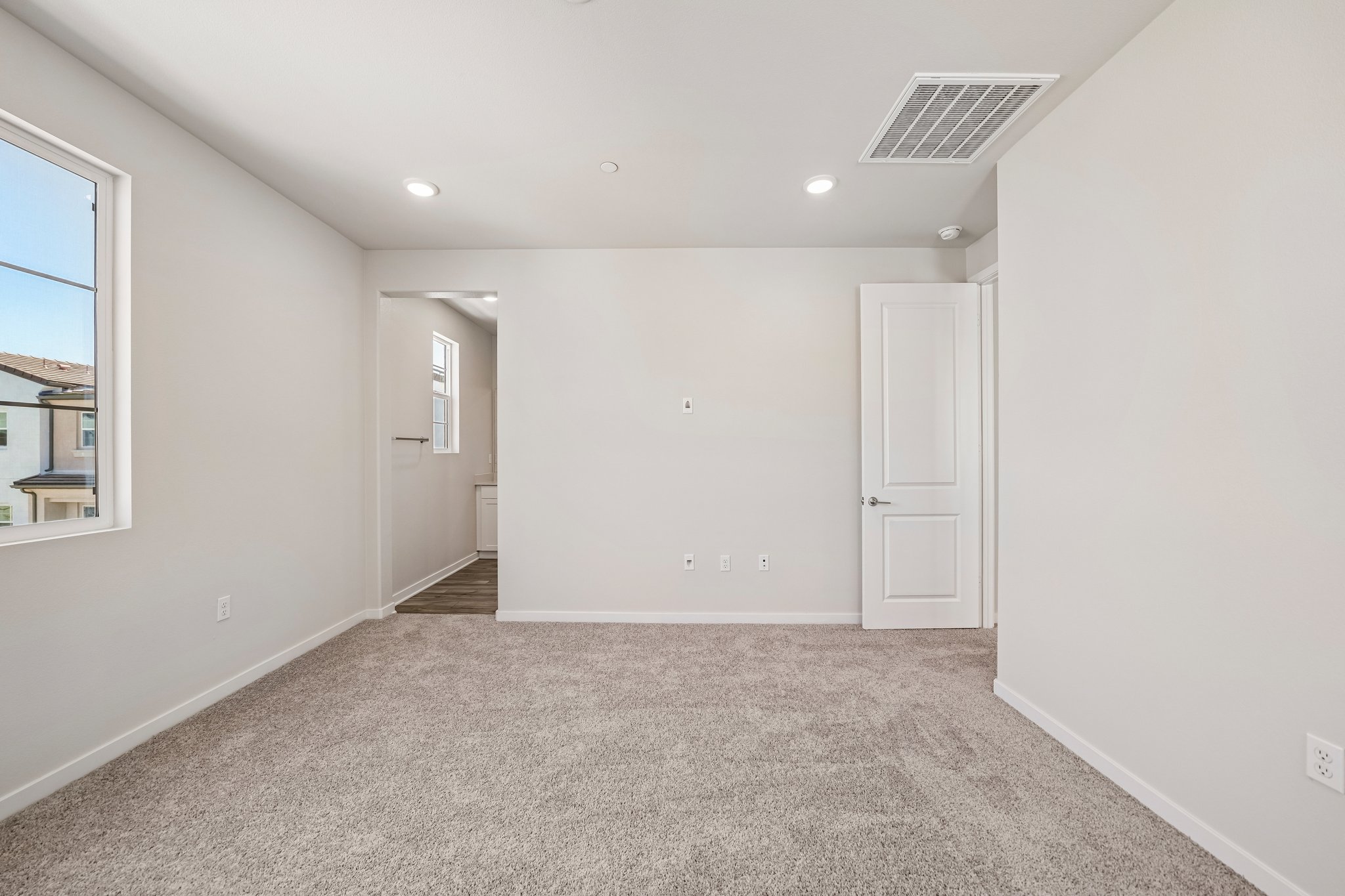 A room with white walls and a carpeted floor.