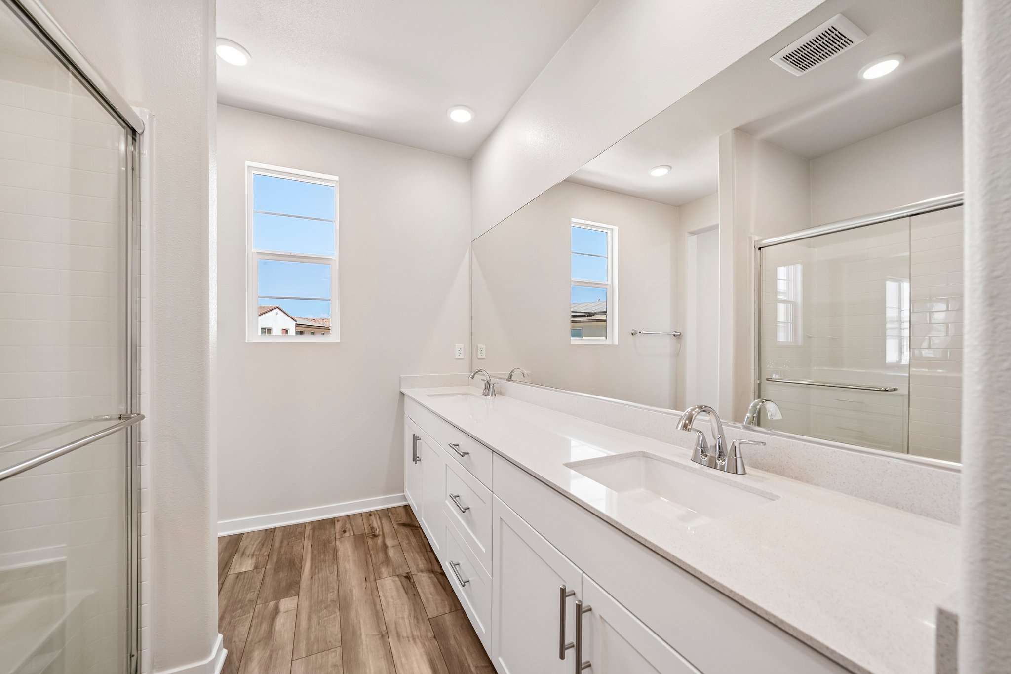A bathroom with a large mirror.