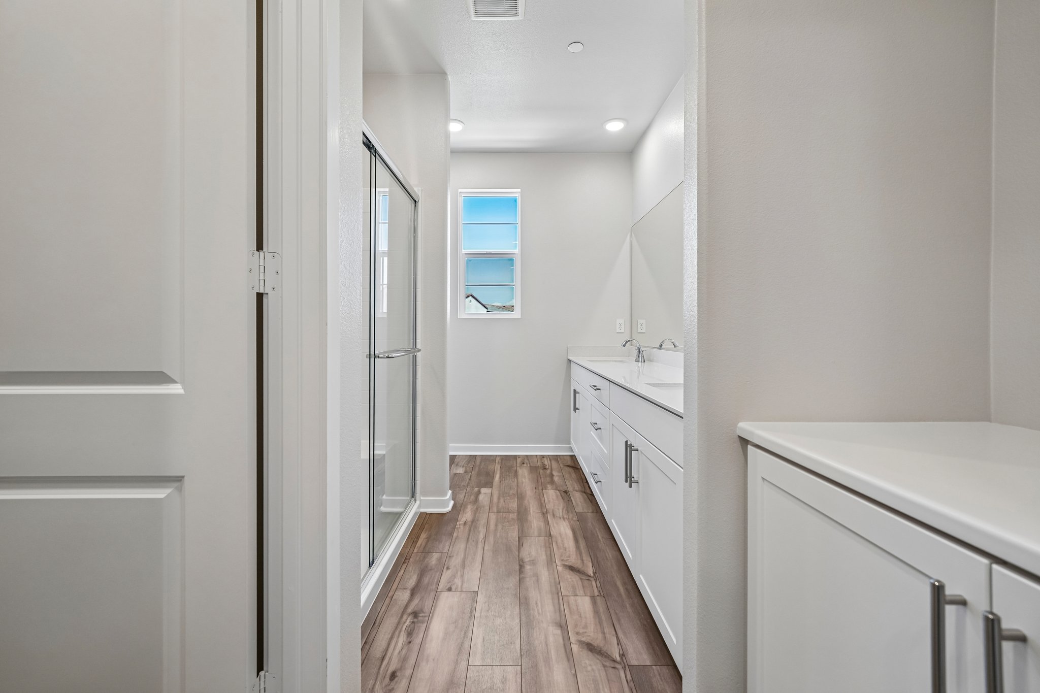 A room with white walls and a wood floor.