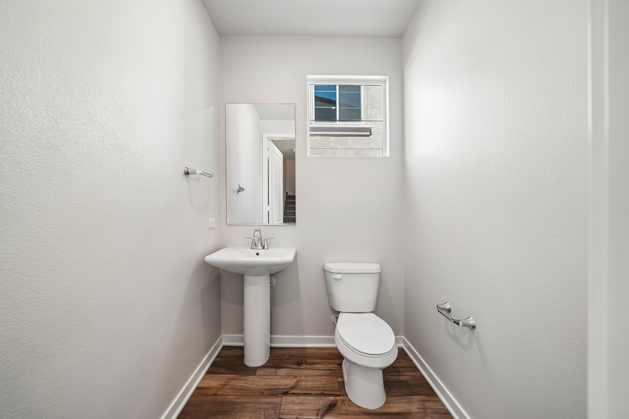 A bathroom with a toilet and sink.