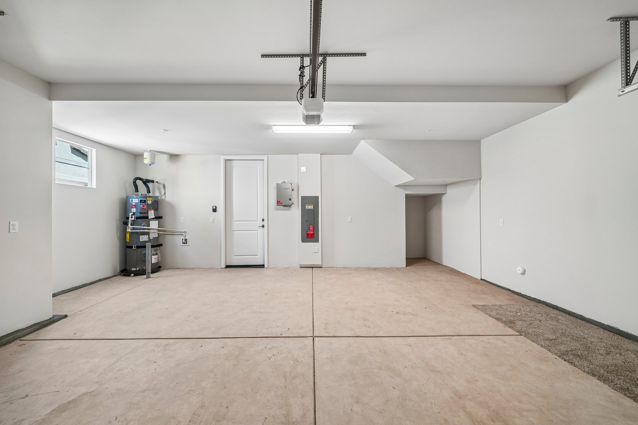 A room with white walls and a ceiling fan.