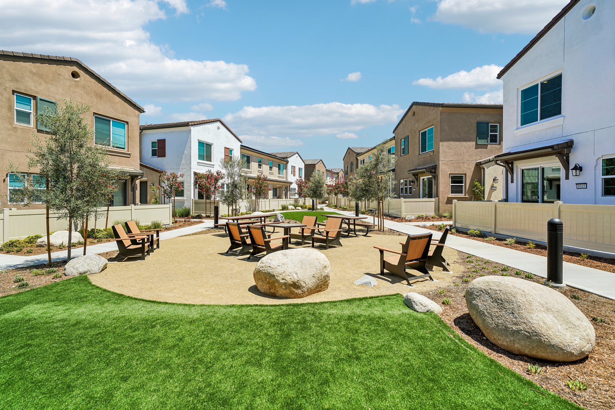 A backyard with a picnic table and chairs.