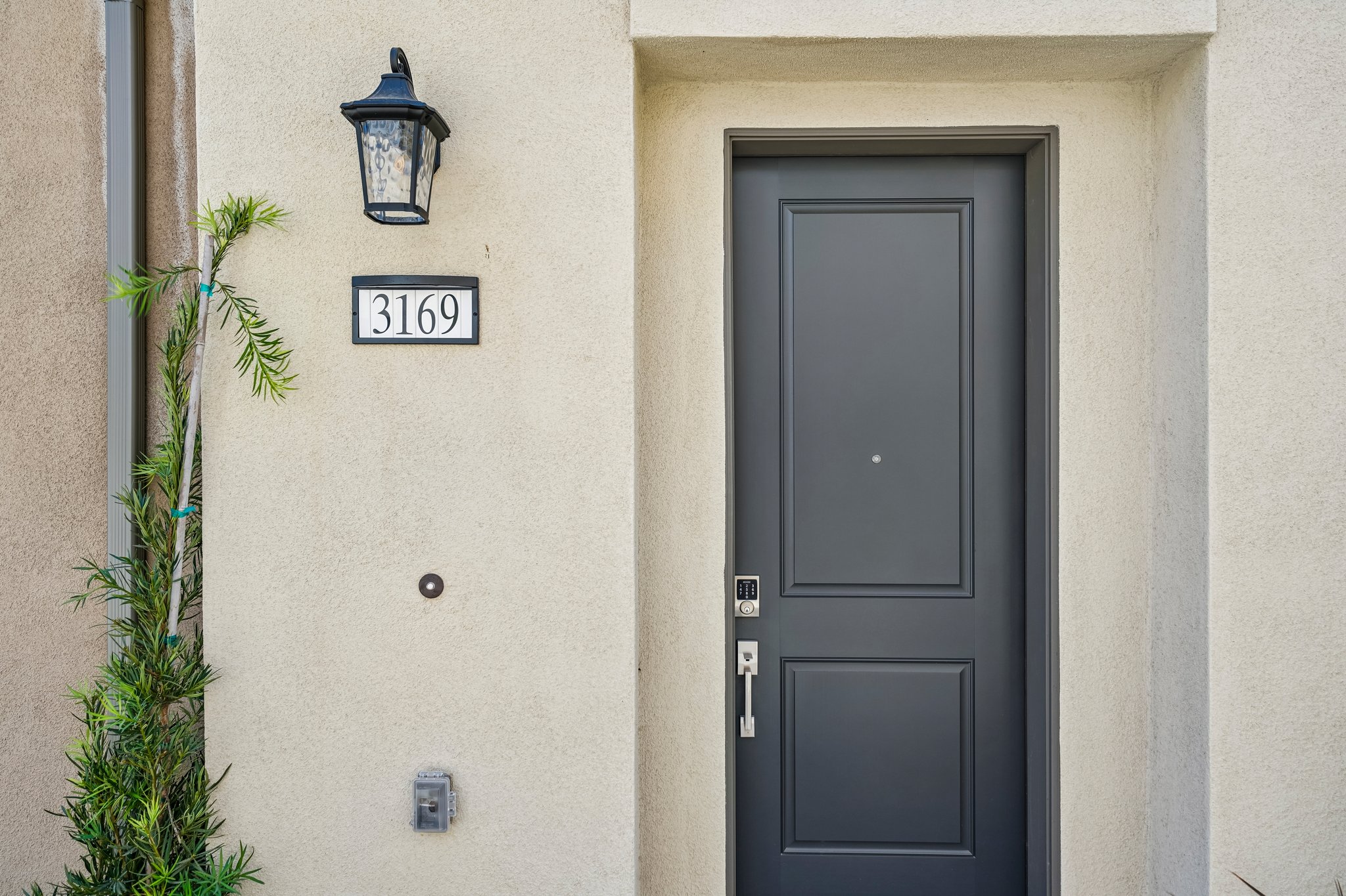 A black door with a lamp on top.