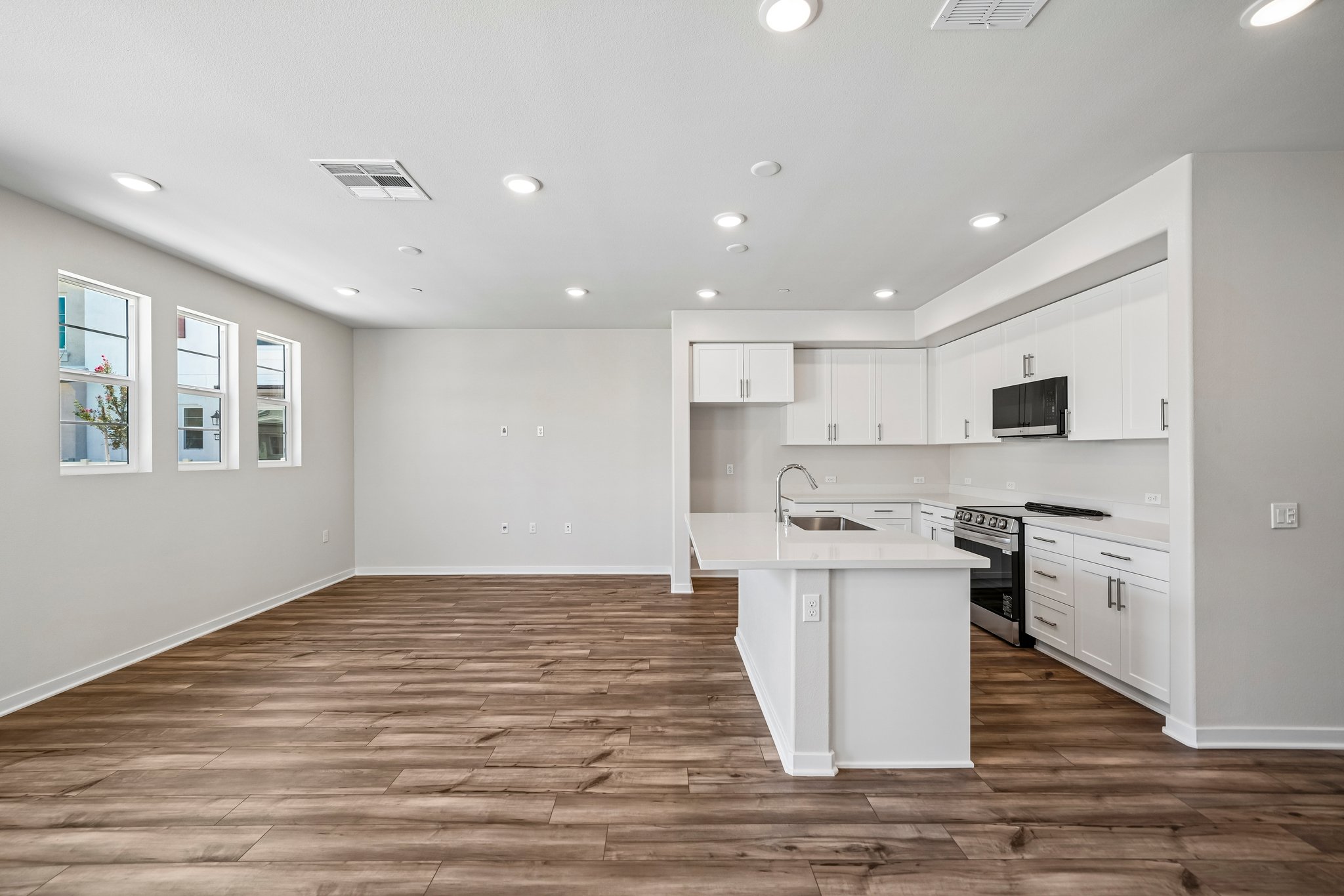 A kitchen with white cabinets.