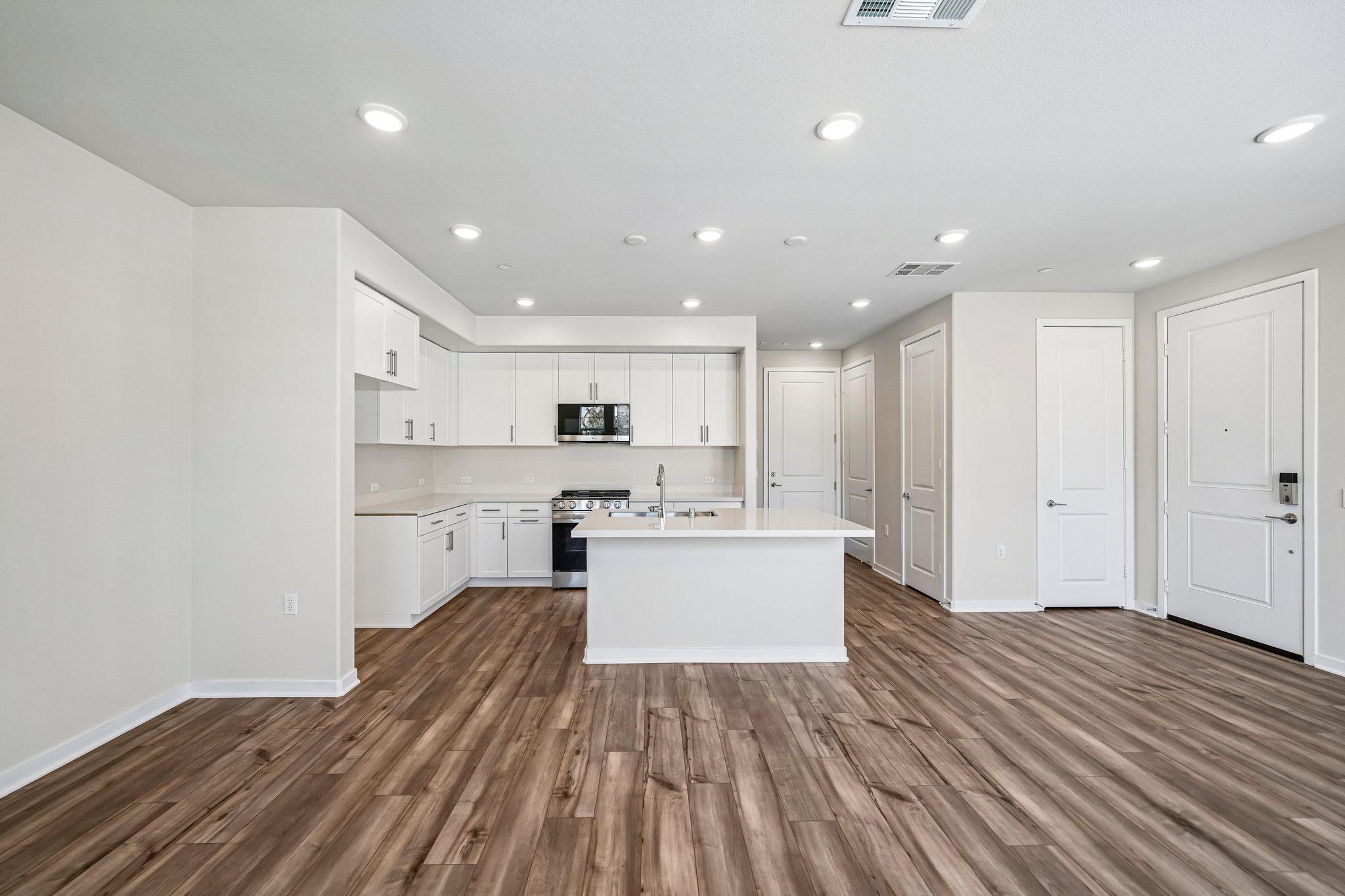 A kitchen with white cabinets.