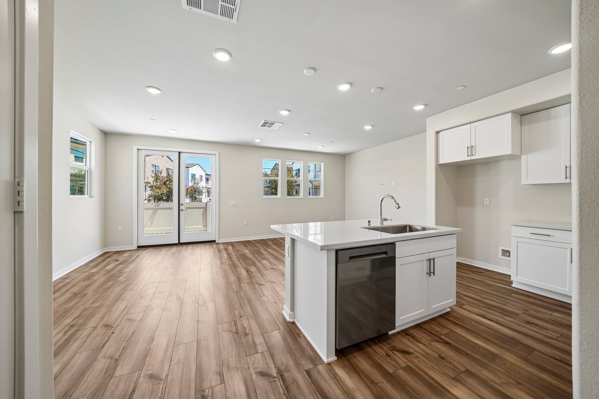 A kitchen with white cabinets.