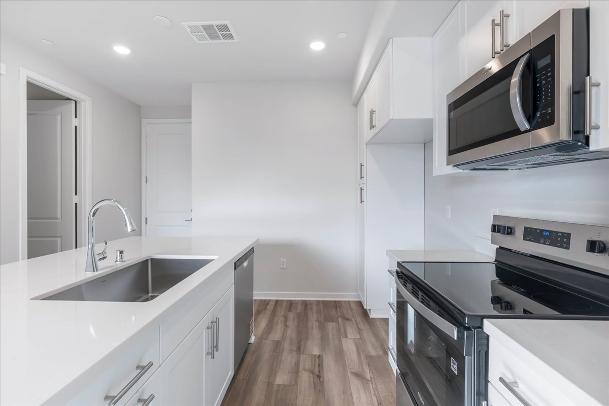 A kitchen with white cabinets.