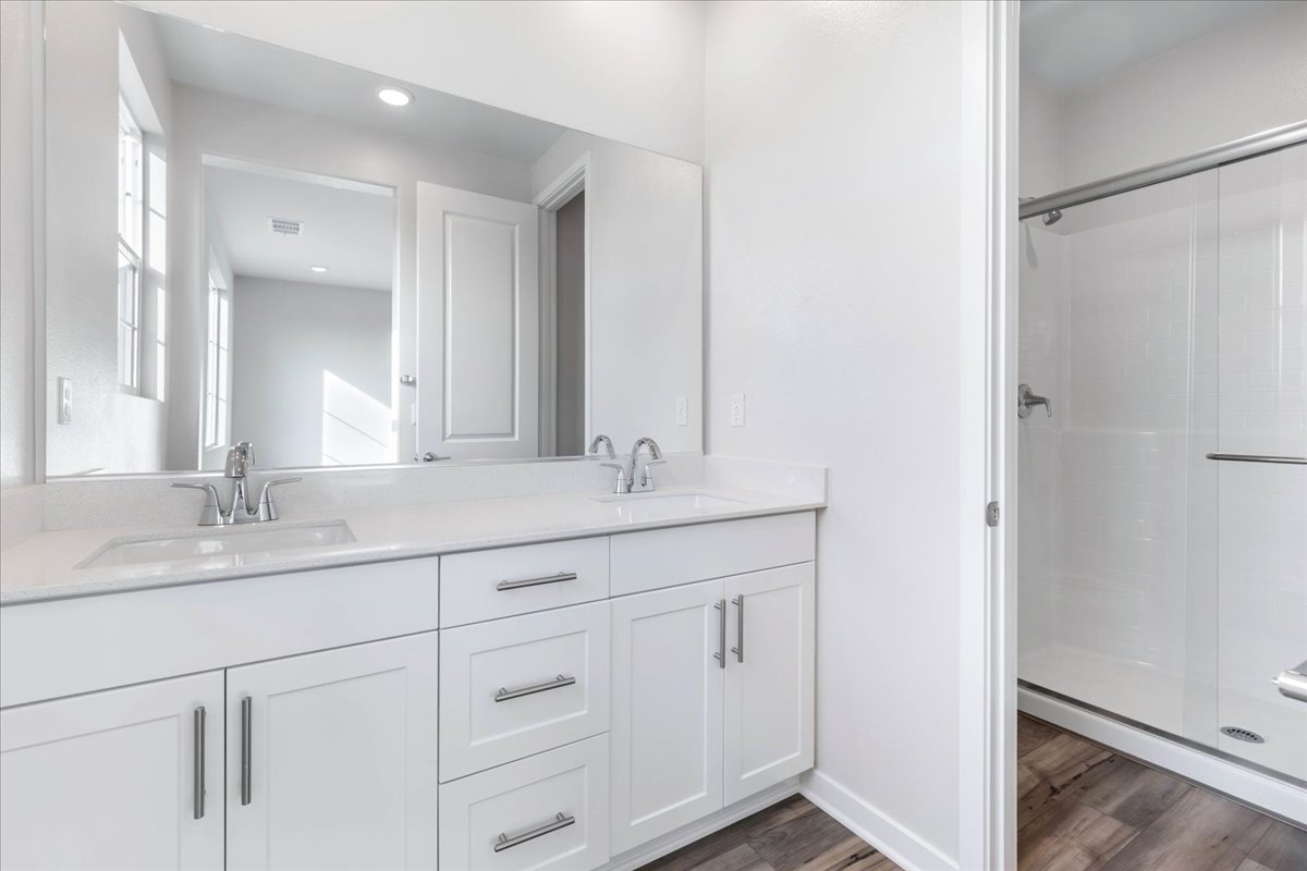 A bathroom with white cabinets.