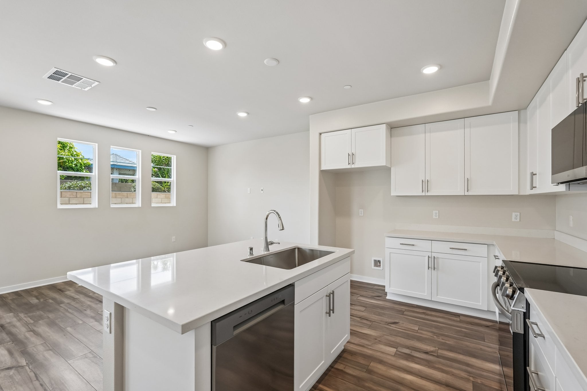 A kitchen with white cabinets.