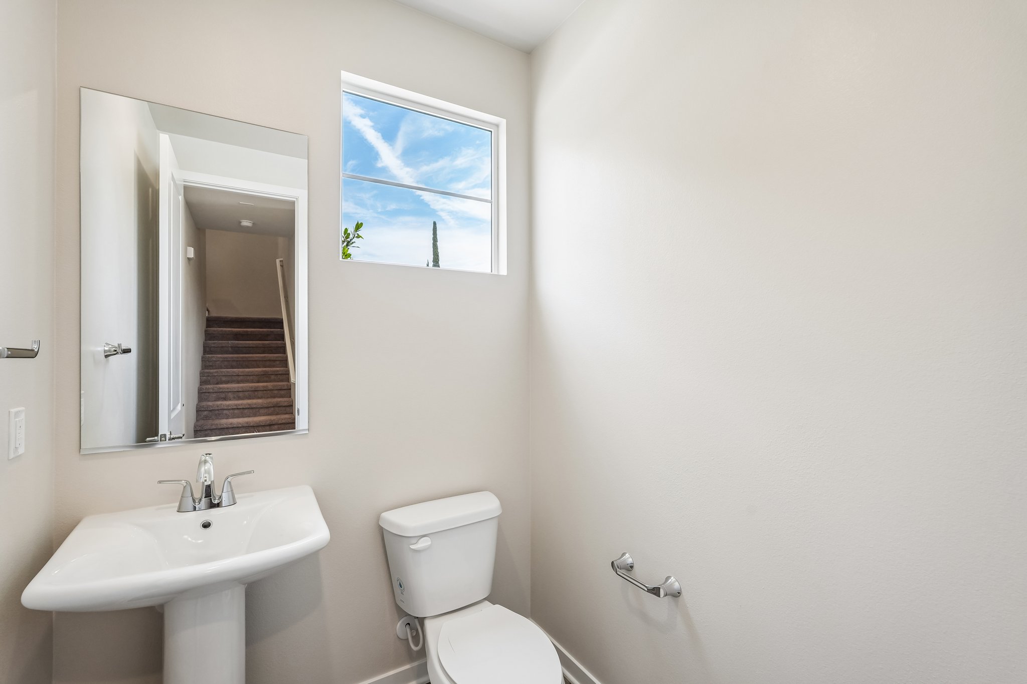 A bathroom with a toilet and sink.