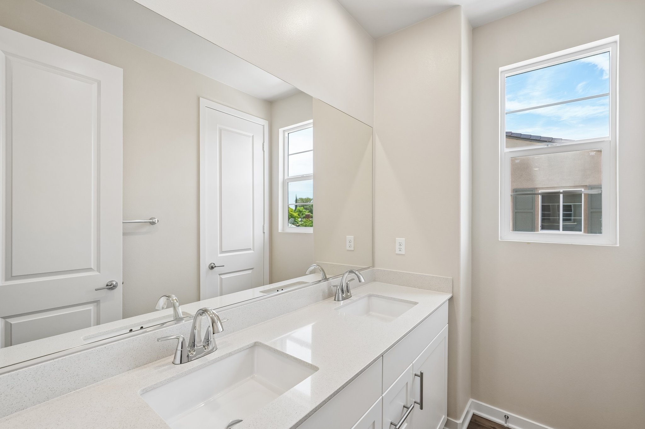 A bathroom with a large mirror.