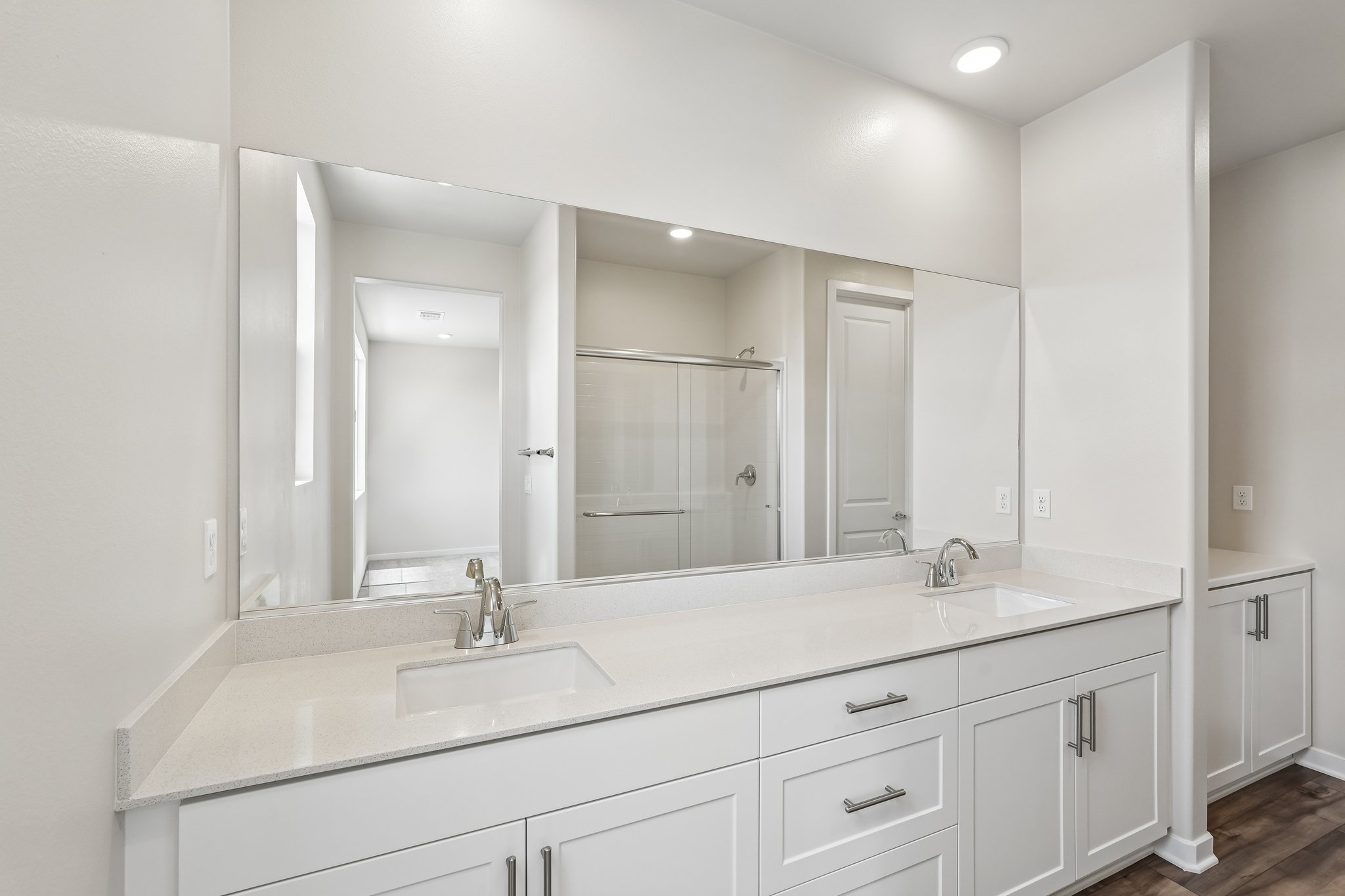 A bathroom with a large mirror.