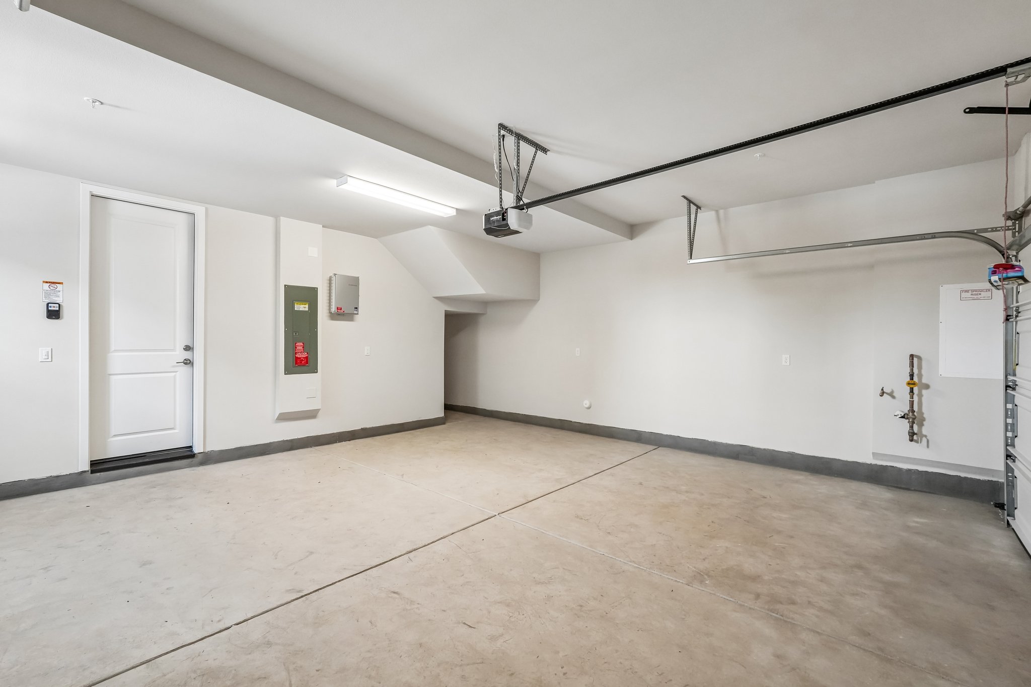 A room with white walls and a white door.