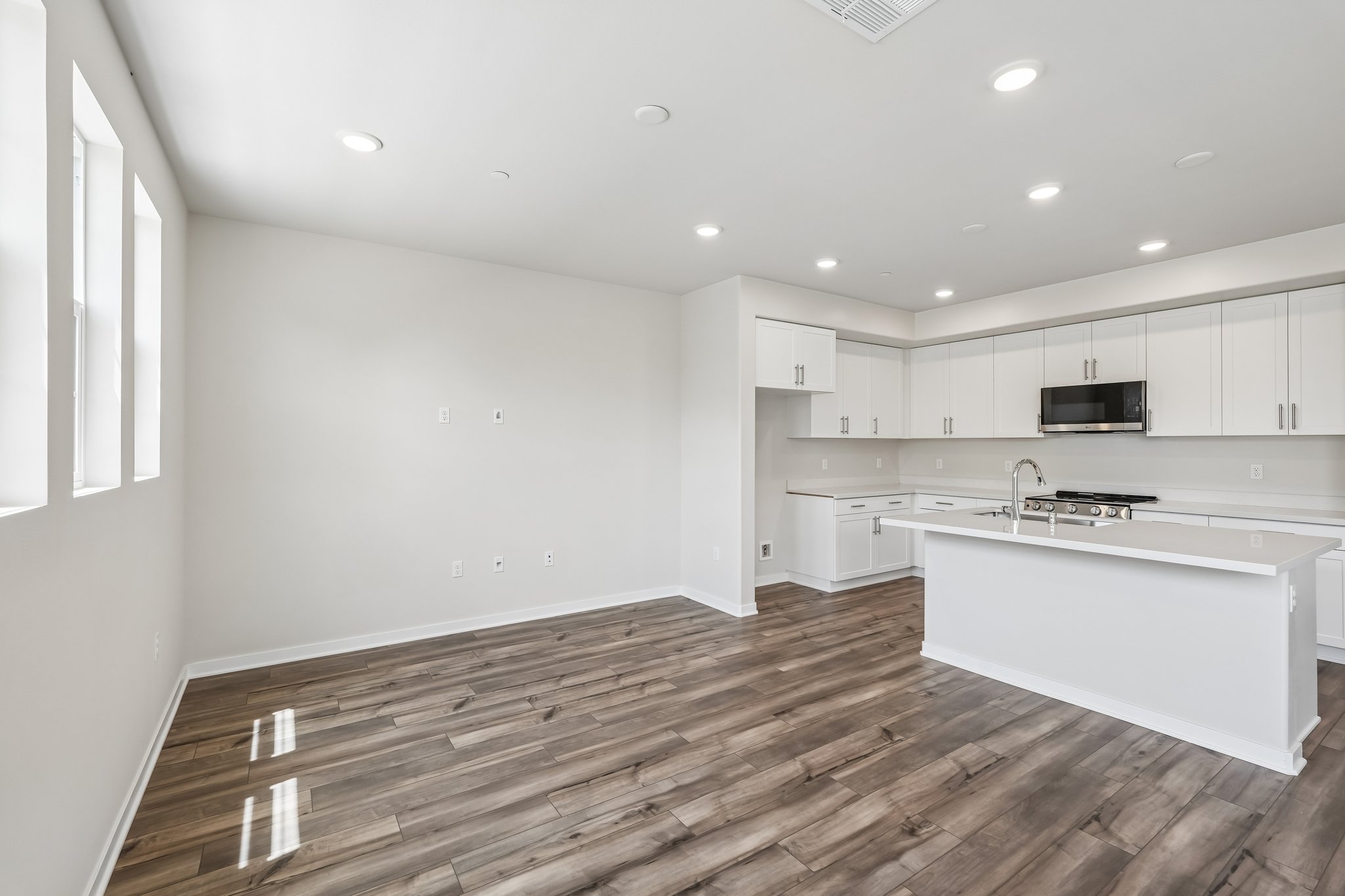 A kitchen with white cabinets.