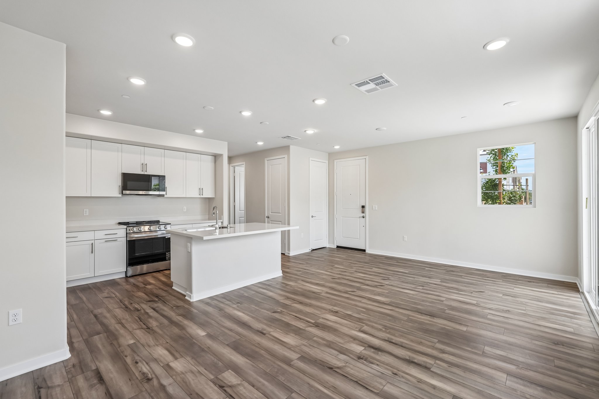 A kitchen with white cabinets.