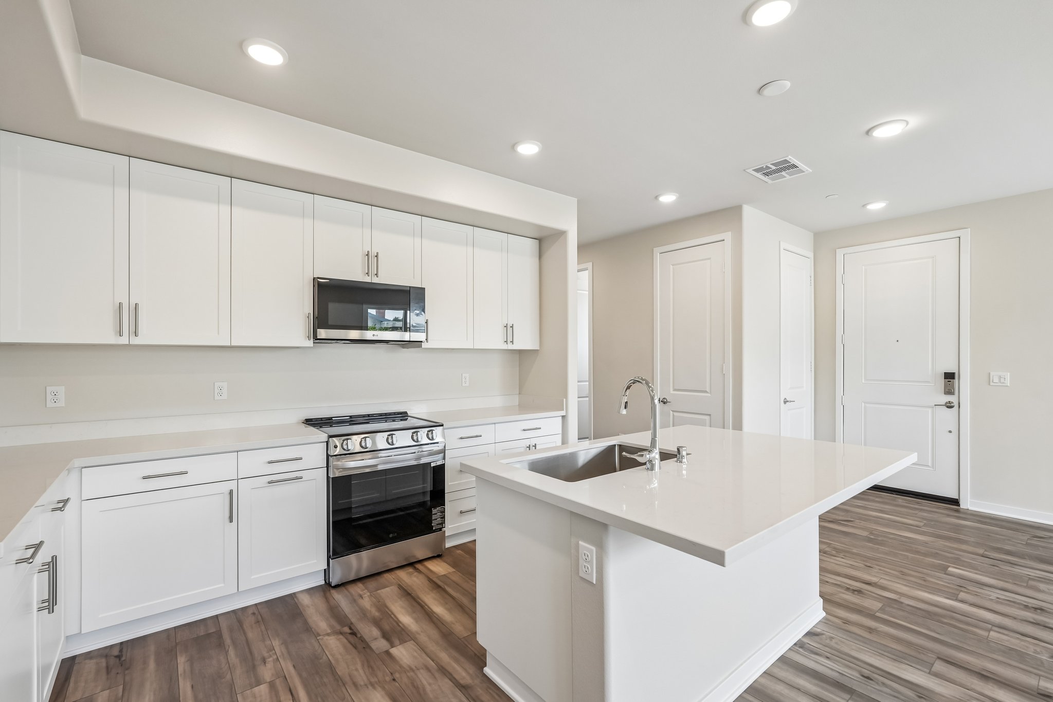 A kitchen with white cabinets.