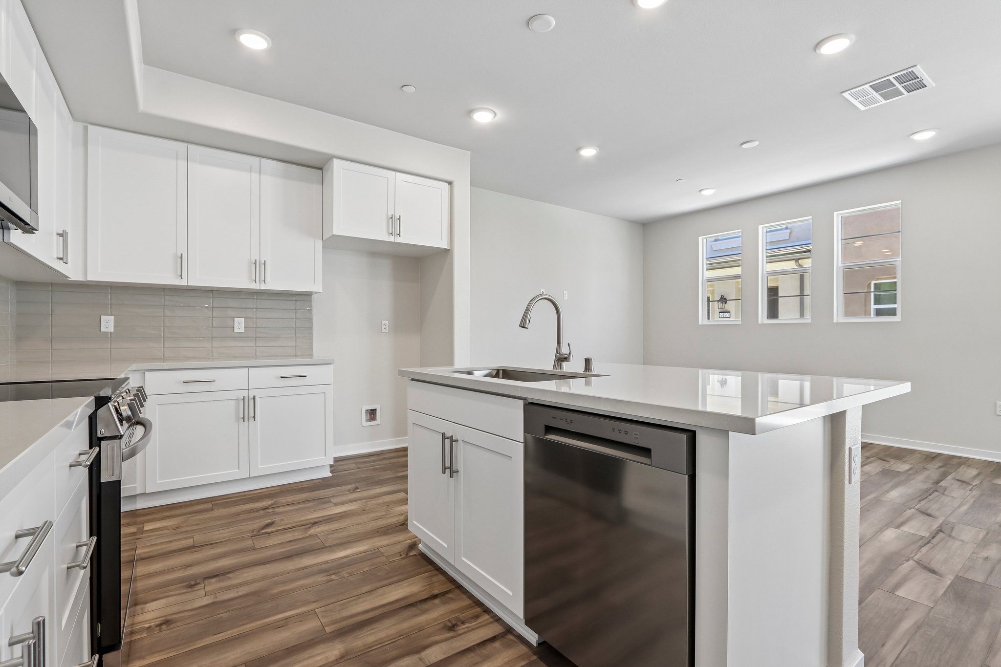 A kitchen with white cabinets.