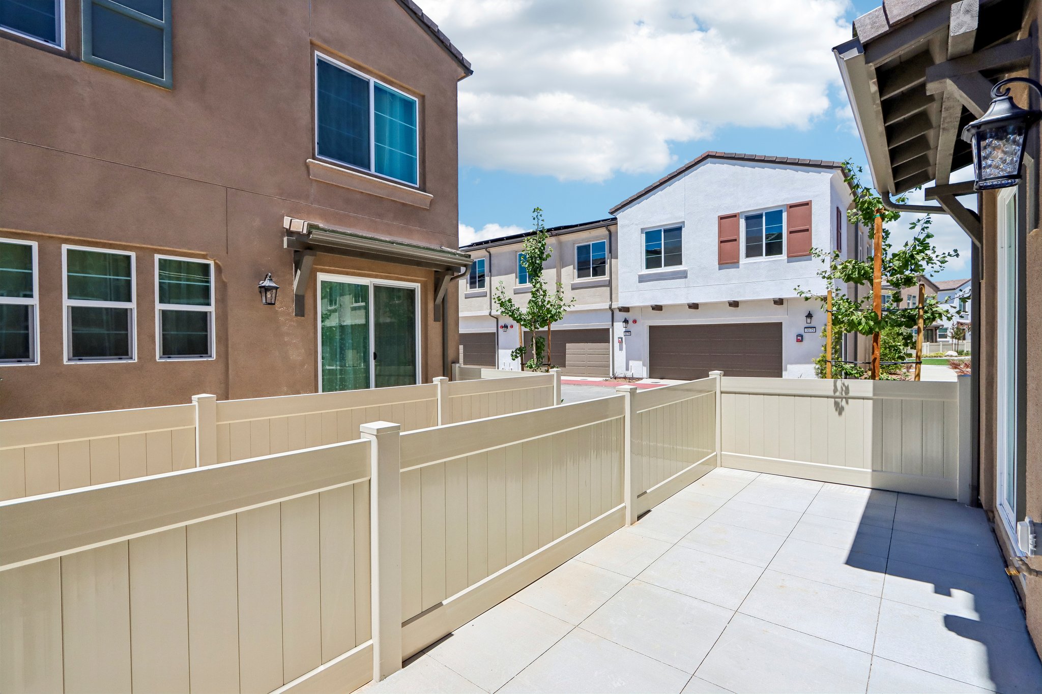 A white fence in front of a building.