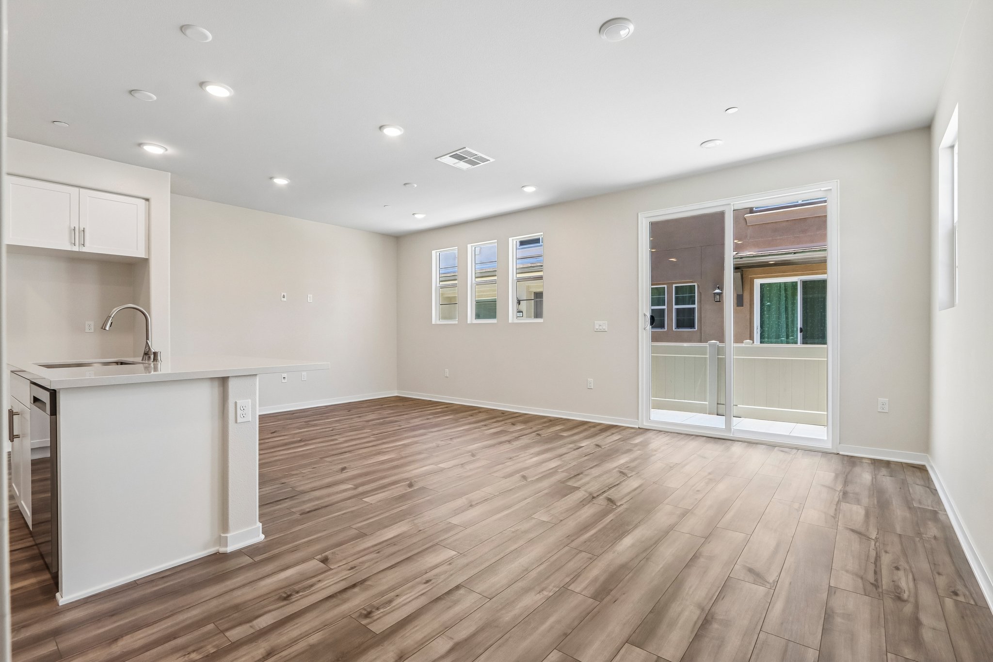 A kitchen with a wood floor.